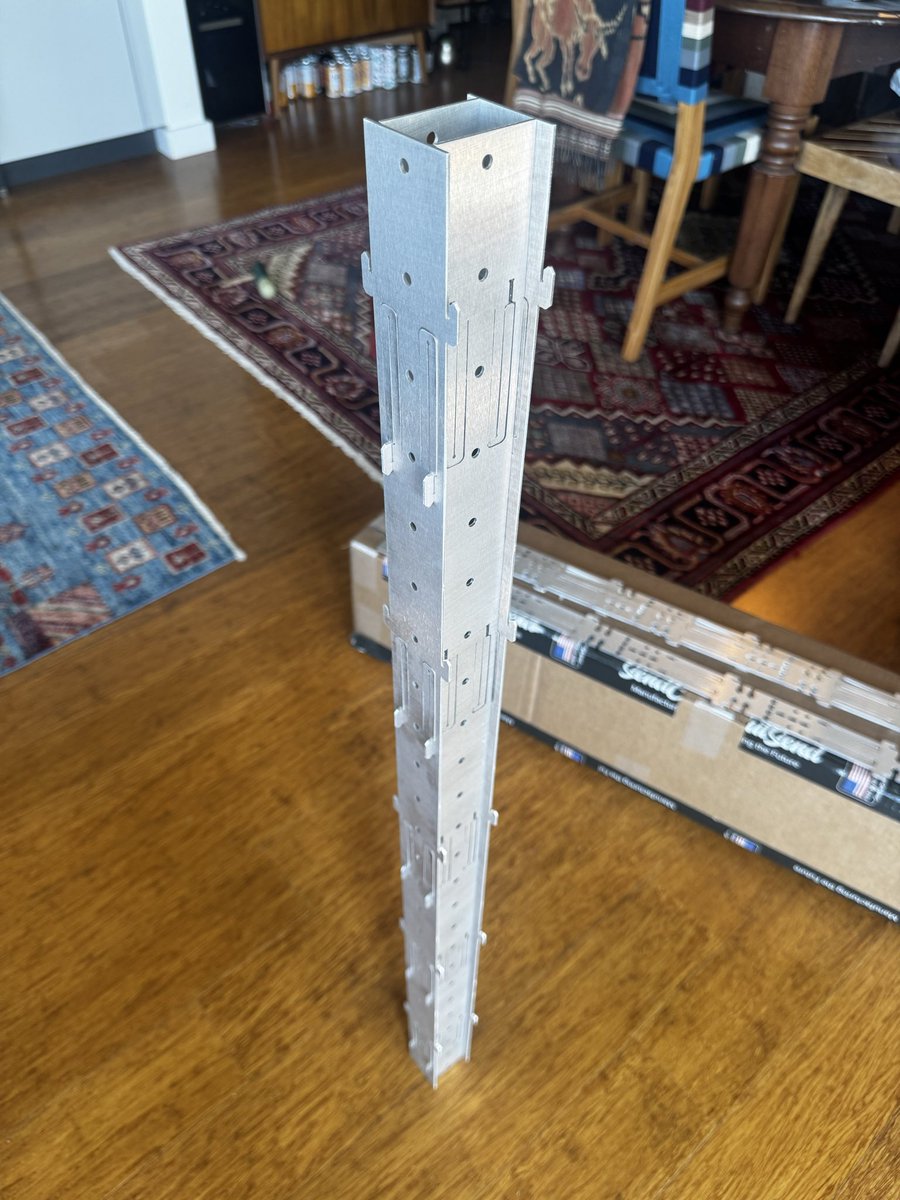 emm0sh's tweet photo. it works. notes:

i prototyped two versions simultaneously: a 1.6 mm thick simplified design (shown in the photo), and a 3.2 mm version (originally shown in the CAD models)

1.6 feels like the best choice -- a balance of weight/cost vs. local strength. i don't think global strength changes much between the two thicknesses

i knew torsional rigidity would be a challenge with the flexure-snap design, and it does lack here. this is because the required clearance to ensure the flexure-snap fit works allows the system to rotate torsionally and parallelogram

additionally, on this torsional rigidity: this parallelogramming would happen anyways even if the tolerances were nailed perfectly. this is a byproduct of "portal frames", i.e. frames that do not have bracing to resolve torsional/moment loads into axial forces acting on chords

torsional rigidity solutions:
a. create more moment resistance at the snap fits (i don't wanna, complicated/expensive)
b. add "webs" -- i have some crazy ideas for this
c. trick the snap fits into acting in a way to do A (frictional fit). we can figure out in 15 minutes of FEA if this will work prior to getting parts released
d. something crazy like long additional flexures that act like webs when they're pulled into place in opposing chords (unlikely to work if they ever need to act in compression due to buckling)

the center holes should be slots, but i wanted to prove the concept before going deeper into detail design

cost: i think it's less than equivalent 8020. i need to do a better study to prove it. but things can only get better from here with refinement

fun note: the snap fits were the main axial loading failure mode (buckling failure), but by looping them back on themselves i'm able to put them into tension, removing this failure type

finally: i think i'm keeping the flexure-snap fit locating design. it was a pain for install because I had too many of them, but they can work if i reduce the count. i will try reducing by 1/3