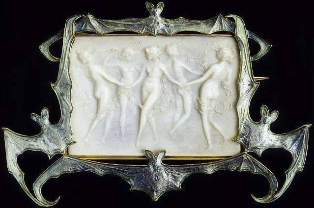 timidfaerie's tweet photo. ‘dancing nymphs in a frame of bats’ brooch: centering on a carved french artificial ivory plaque, depicting five dancing nymphs in relief, w/in a blue enamel bat frame, mounted in 18k gold https://t.co/3smCyHHiZ6