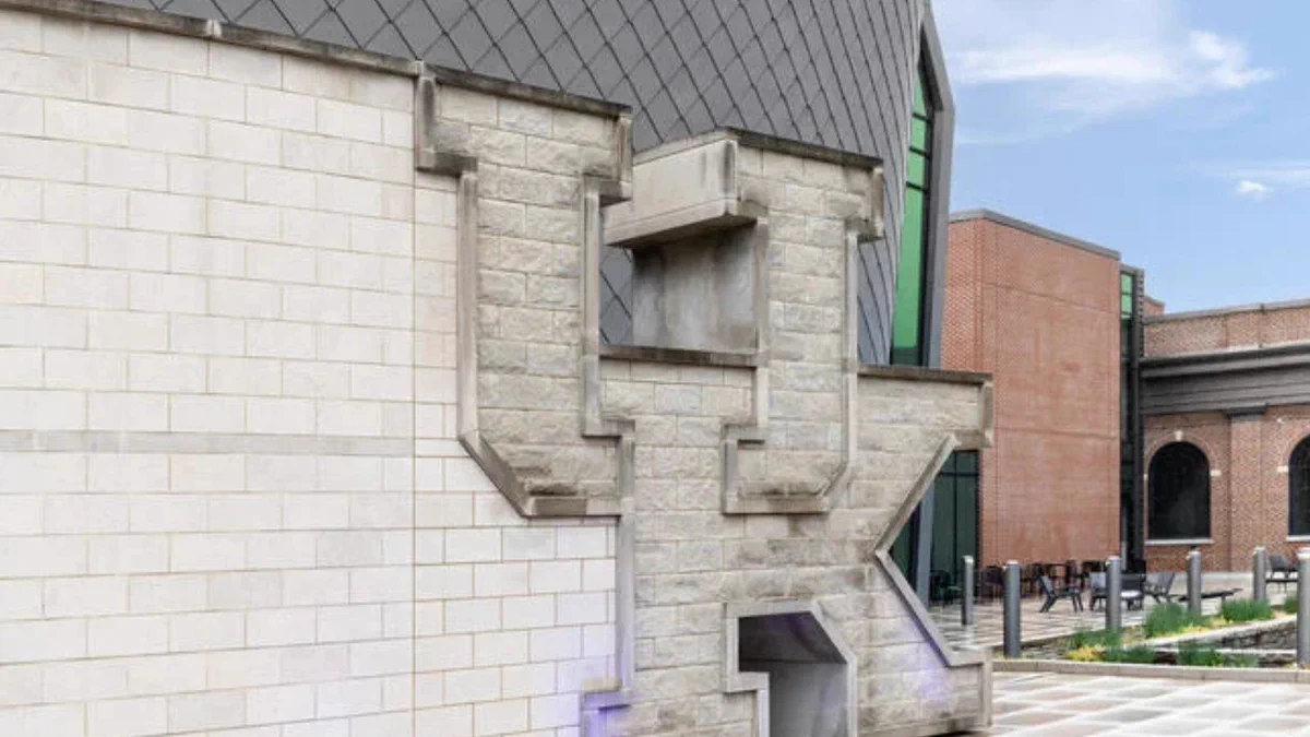 A photo of the brick side of a building with brick letters spelling out "UK," the University of Kentucky logo.