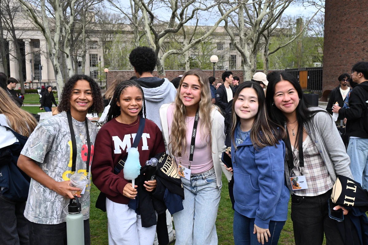 Five students standing outside at the Greek Carnival in spring 2026.