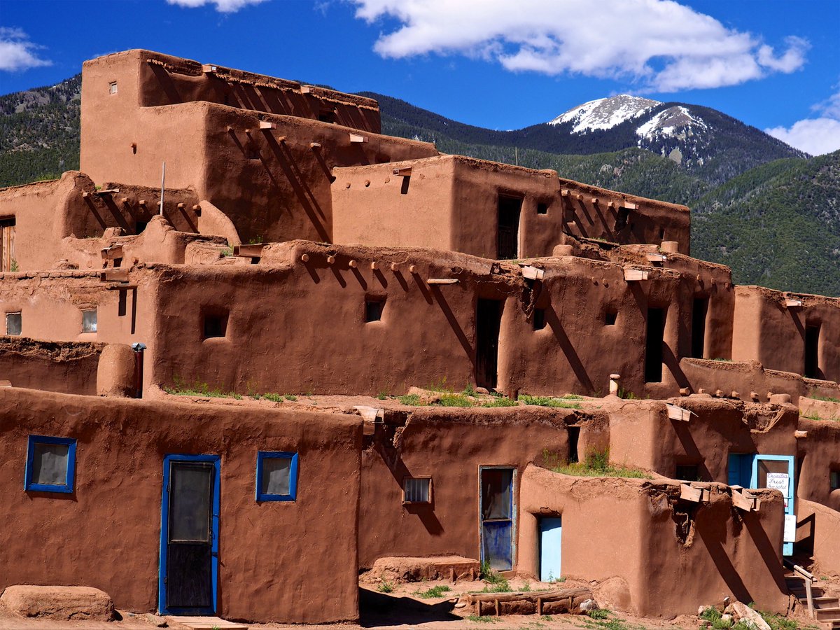 Thibault1618's tweet photo. Pueblo architecture represents a highly refined earth-building tradition adapted to the arid climate of the American Southwest. 🏜️

Key technical and cultural features:
• Multi-storey construction in adobe or stone
• Thick walls providing high thermal mass
• Small openings to limit heat gain
• Flat roofs with careful drainage
• Communal organisation of space and continuous maintenance traditions
• Use of local earth, timber and stone

Performance characteristics:
• Excellent passive temperature regulation
• Low embodied energy
• Vulnerability to erosion if protective plasters are not maintained
• Strong cultural continuity in construction and repair methods

Conservation must respect both the material behaviour of adobe and the living traditions that have sustained these buildings for centuries.

Have you worked with historic adobe or Pueblo structures, or similar earthen traditions? 👇

#PuebloArchitecture #Adobe #EarthenArchitecture #VernacularArchitecture #CulturalHeritage