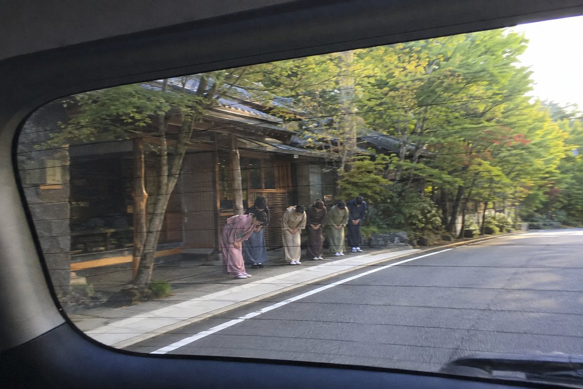 japan_nobunaga's tweet photo. Stay one night at a traditional Japanese inn
and the goodbye will break you a little.

You arrive. Your shoes vanish.
They come back cleaned, turned around,
pointing toward the door for the day you leave.

Tea appears before you think to ask.

You go down to dinner, and while you eat,
someone slips into your room and lays out your futon,
folds back the sheets, dims the lamp.
No note. No tip expected.
Tipping doesn't exist here.

Then you leave. And this happens.

The owner walks you out. The staff follow.
The cook comes too, still in his apron.
They line up in the road, and they bow.

Your car pulls away. They keep bowing.

You turn in your seat and watch them shrink
through the rear window, still bowed,
until the road bends and takes them away.

They don't stop when you stop looking.

Every hotel I've ever stayed in gave me service.

This was a family in the middle of a mountain road,
bowing to a stranger,
thanking me for letting them take care of me.

I cried in the car.
I'm not even a little ashamed.