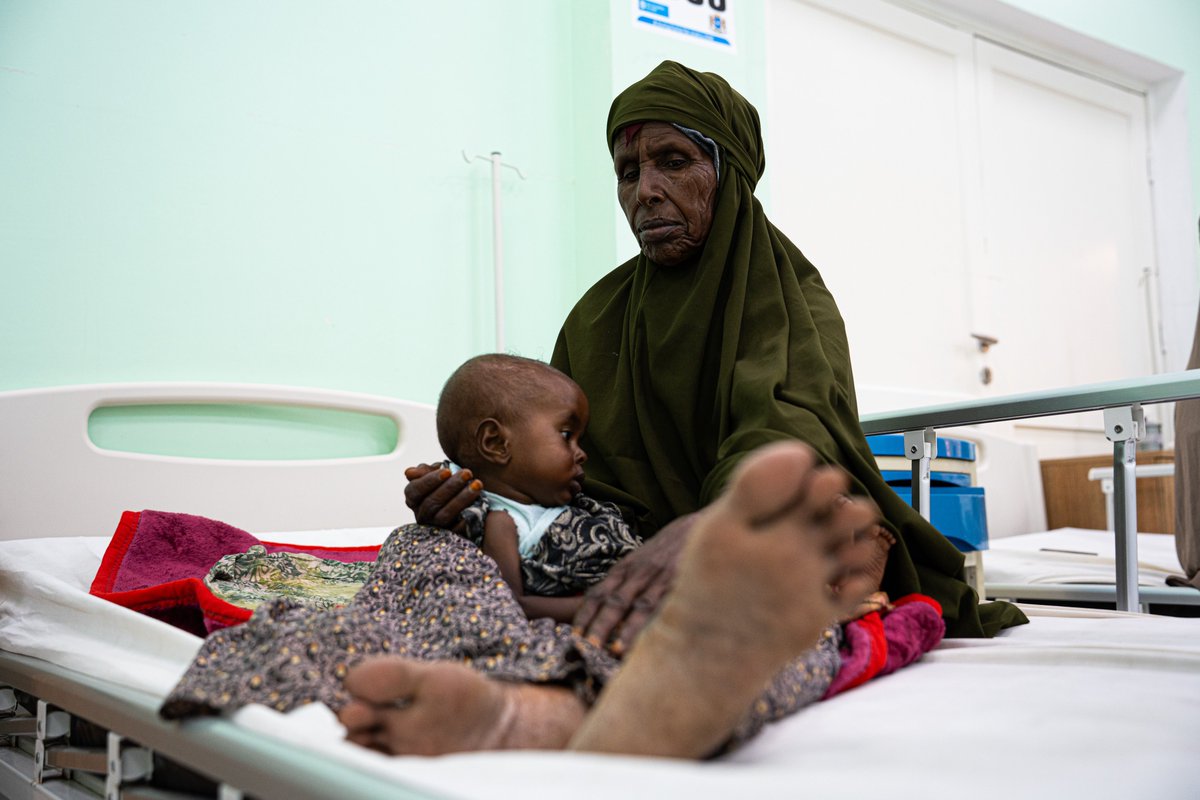 NRC_Egeland's tweet photo. Abdullahi - 9 months old - lost his mother shortly after childbirth and is now cared for by his grandmother Sharifa. 

Sharifa comes from a pastoral community and once owned more than 28 cows, which enabled her to support her entire family from the milk and the meat.
The drought killed all of her livestock and she had to travel all the way from Hirshabelle State to Mogadishu, to get lifesaving care for her grandchild. 

The drought has devastated one community after another, and aid cuts mean that many, many children will not receive care like little Abdullahi, and as a result are now succumbing to easily preventable death.