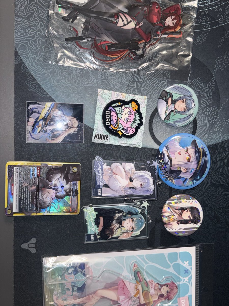 SLICE_AND_DUIS's tweet photo. All the NIKKE goodies I got at AnimeNYC and cards I recently pulled 😏 https://t.co/FlSIpUlDu7