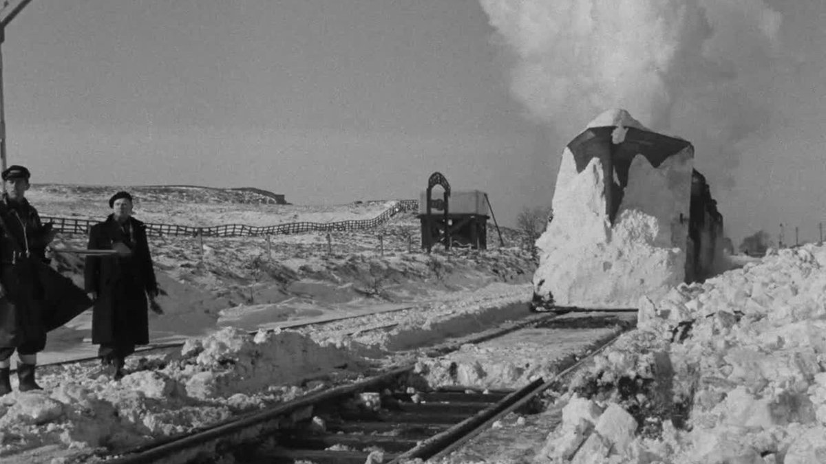 timelessbritain's tweet photo. On a winter night in 1955, a freight train travelling between Kirkby Stephen and Barnard Castle became stuck in deep snow at Bleath Gill in the Westmorland hills.

The railway line crossed Stainmore Summit, one of the highest points on any railway in England. Wind, ice and huge snowdrifts stopped the train in its tracks, leaving the crew stranded as the weather closed in.

Then the rescue began.

Railway workers from the Motive Power, Operating and Engineering Departments battled through the conditions with snowploughs, tools and determination. They cleared the line, freed frozen equipment and slowly fought their way towards the trapped locomotive.

A British Transport Films crew followed the rescue effort and captured the struggle on film. The result was “Snowdrift at Bleath Gill”, a short documentary that turned an ordinary railway emergency into a remarkable record of teamwork in one of Britain’s harshest landscapes.

The men involved were not celebrities. They were railway workers doing a difficult job because a train, its crew and a vital route needed saving.

The film also preserves a lost world of British railways, when remote lines depended on the skill and courage of the people who maintained them through every season.

Today, the Stainmore route is closed, and the steam locomotives that once crossed these hills belong to another era. But the faces of the workers who cleared the snow remain, frozen in time, showing the quiet effort that kept Britain moving.