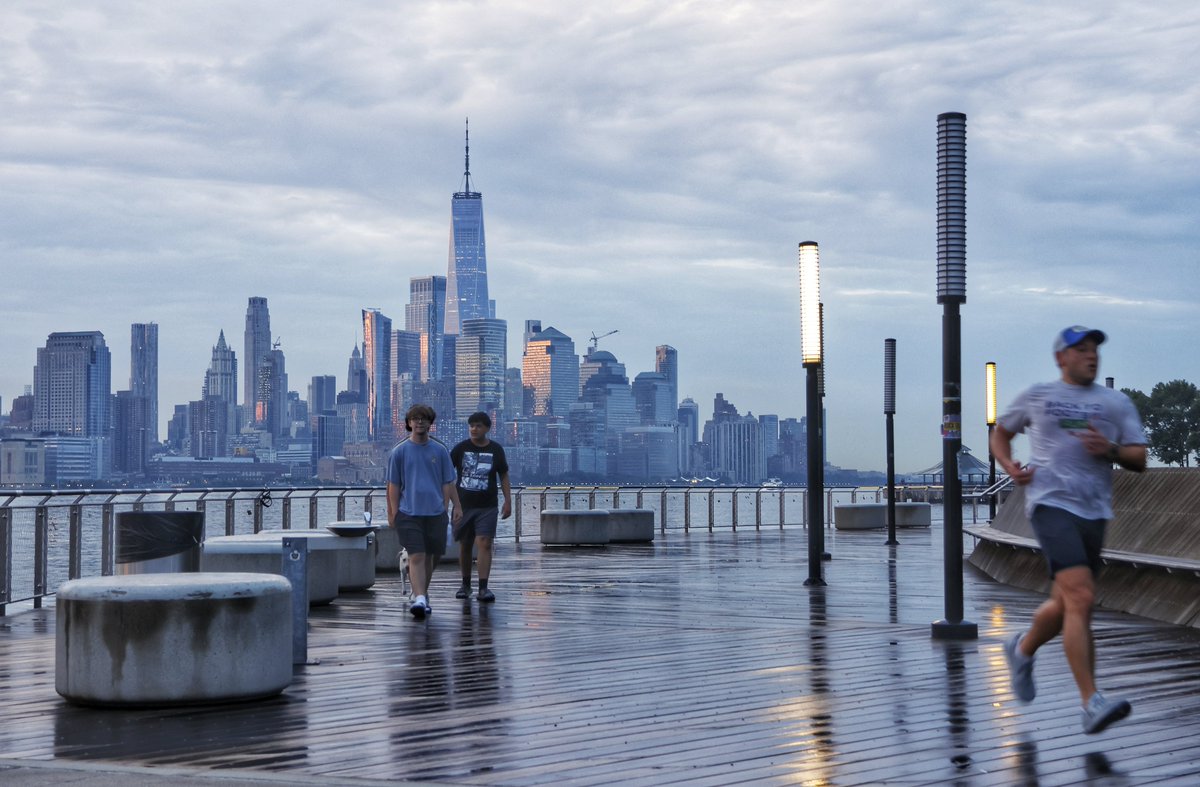GaryHershorn's tweet photo. Early risers along the waterfront in Hoboken, NJ as the sun rises in New York City Friday morning #newyorkcity #nyc #newyork #sunrise https://t.co/qyOCnq0xNd