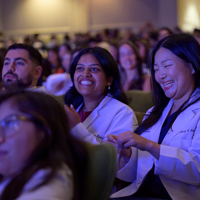 Medical students clapping at the conclusion of the White Coat Ceremony
