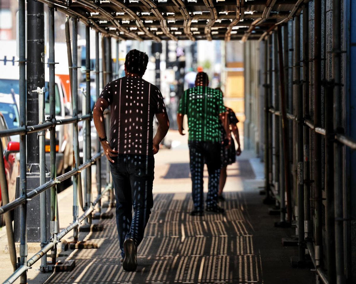 BorisFranzese's tweet photo. Polka-dotted beams of light shine on pedestrians beneath a sidewalk canopy at a development on Barrington Street this afternoon. https://t.co/RThkiFgQab