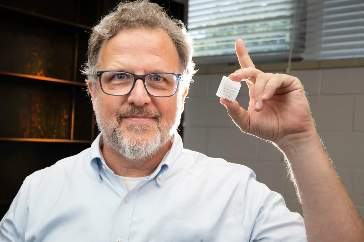 ISE Professor Eric MacDonald holds a 3D-printed ceramic Luneburg lens. MacDonald compares the lens to a magnifying glass that focuses sunlight, except the lens focuses Bluetooth signals instead.