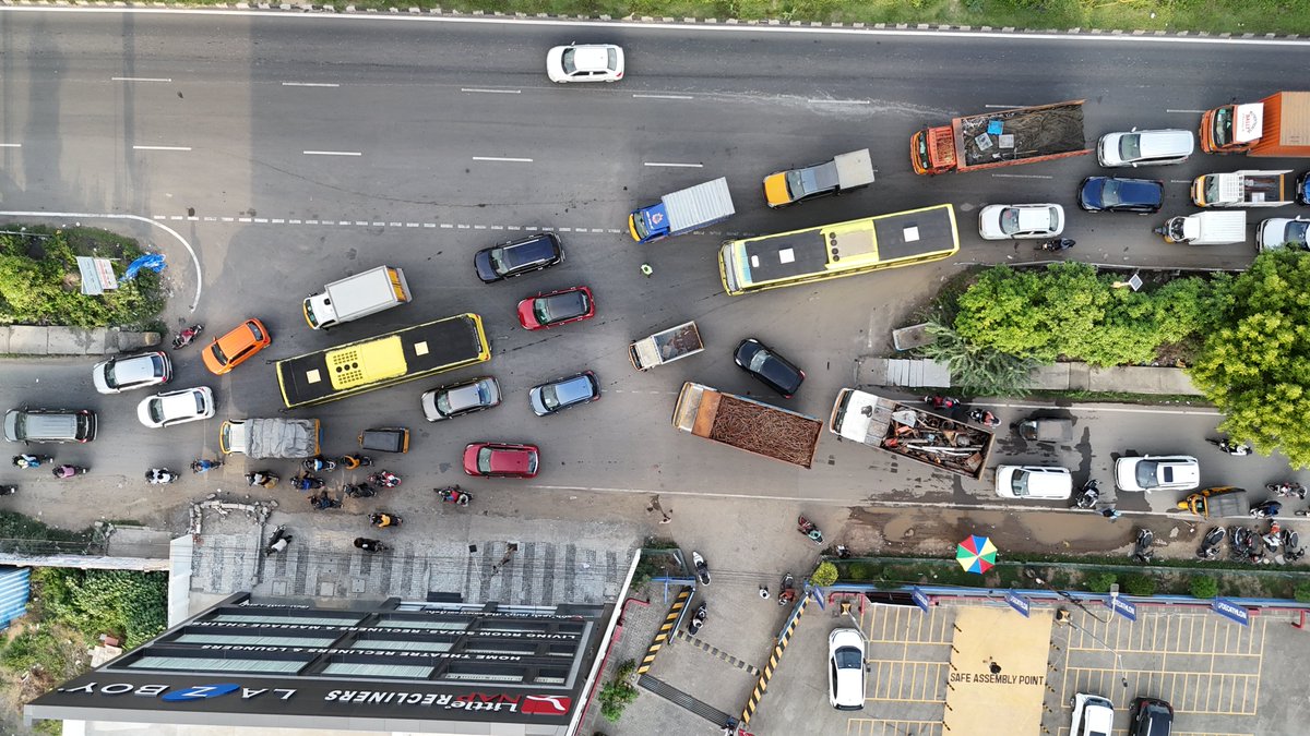 kumarpolitician's tweet photo. 1. Too many conflicting movements at one opening

The same small opening is used by:

• Vehicles exiting the bypass
• Vehicles entering the bypass from the service road
• Vehicles making U-turns
• Vehicles proceeding towards Ambattur Estate signal

These movements conflict with each other and interrupt traffic flow.

2. A narrow Z-bend beneath the bypass

Most vehicles exiting the bypass proceed towards Ambattur Estate signal through a narrow Z-bend. Currently, traffic passes through only one opening between two bridge pillars.

When many vehicles reach the bend together, they compete for the limited space and the flow slows considerably.