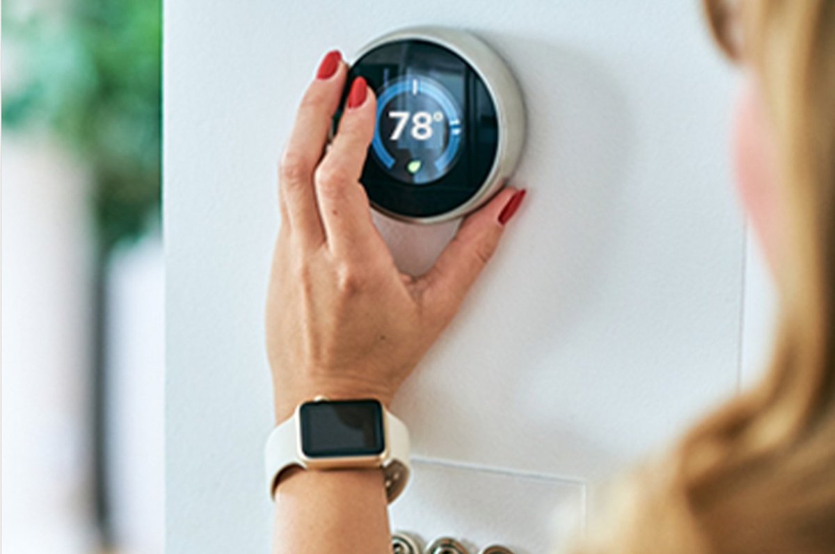 Person adjusting thermostat to 78 degrees