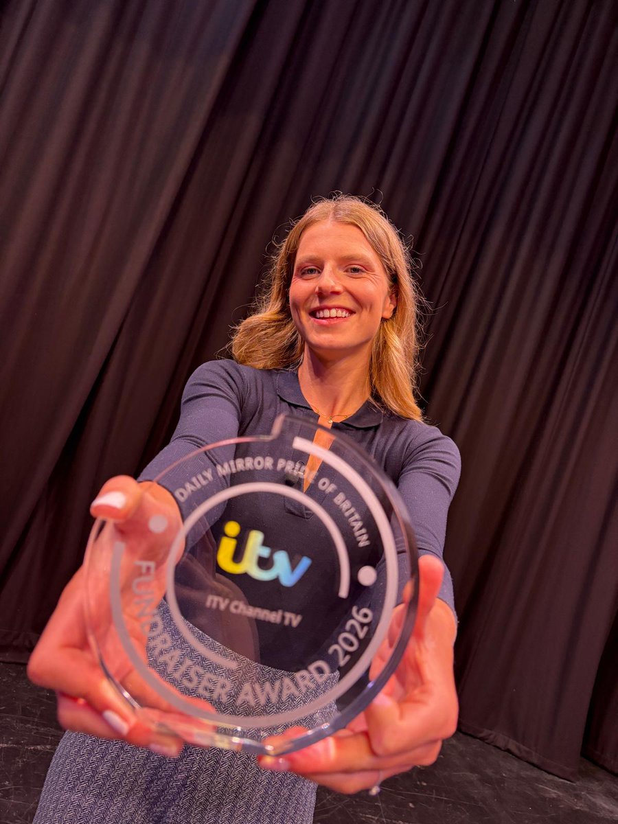 Lily Carter smiles and holds out a glass trophy that says 'Daily Mirror Pride of Britain - ITV Channel TV - Fundraiser Award 2026'