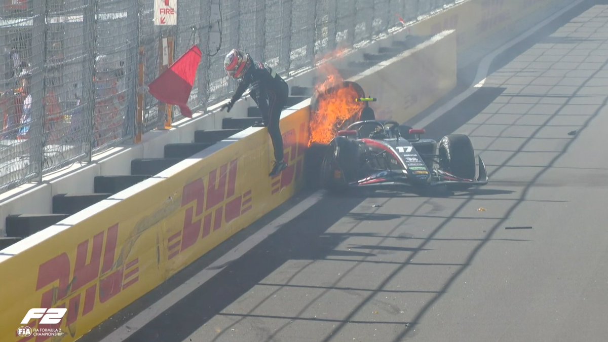 Formula2's tweet photo. RED FLAGS 🚩

Tasanpol Intharphuvasak hits the barrier at Turn 19 as his car catches fire 

The Thai driver is out of the car and behind the barrier. He's all ok 👍

#F2 #SpanishGP https://t.co/iIGEFk1CcN