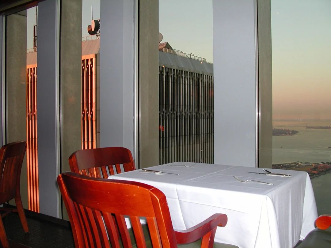 MarioNawfal's tweet photo. 🎗️🇺🇸 These are some of the last photos ever taken inside the World Trade Center’s North Tower.

A night shift worker captured them shortly before 9/11.

And there’s nothing dramatic about them, which somehow makes them hit harder.

Empty tables still set for guests. Chairs pushed in.

The lights glowing over a quiet dining room while New York stretched out below.

Even the neighboring South Tower can be seen through one of the windows.

They’re basically ordinary snapshots of a place where everyone expected another normal day to follow.

Then came the morning of September 11.

25 years later, these photos are a quiet little time capsule of the North Tower before everything changed.

Source: r/TwinTowersInPhotos / Writer: Daniyal