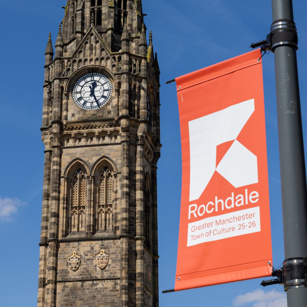 A town hall and a flag which reads - Rochdale, Greater Manchester Town of Culture