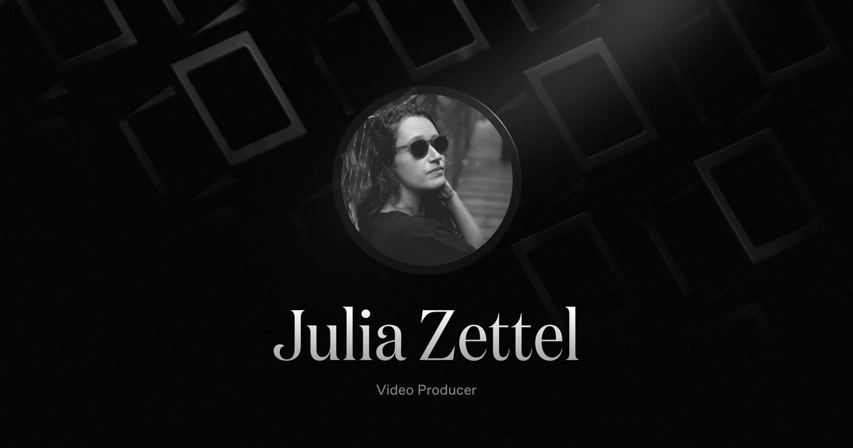Julia, with dark, wavy hair and sunglasses poses thoughtfully against a textured black background, showcasing her role as a Video Producer.