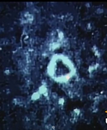 BrianRoemmele's tweet photo. The Triangle On The Moon You Never Saw

If you stood in it, and looked up, you would see Earth in a way no other place on the moon could deliver.

Ukert does not look like a textbook crater.

Most lunar impact scars are circles or ellipses. Ukert refuses to play along. Its rim swells outward on the north and east, producing a shape that from certain angles reads as an almost-perfect triangle—or at least a sharply polygonal “O” with one side flattened and two corners pulled. 

That geometry is what jumps out in the close-up you shared: a bright, slightly lopsided ring sitting on the dark, pocked highland like a geometric stamp the Moon never quite finished rounding.

The crater sits at 7.8° N, 1.4° E, almost dead-center on the near side, on a rugged strip of ancient highland between the dark lava of Mare Vaporum to the north and Sinus Medii to the south. 

It is only 22 km across, yet the irregular outline makes it unmistakable once you know what to look for. 

A low ridge runs across the floor from the center toward the southern wall; a tiny craterlet nicks the northern rim. The whole structure dates to the Lower Imbrian, after the giant Imbrium impact farther north had already carved the linear “sculpture” grooves that Ukert later punched through.

That near-triangular plan is not an illusion of lighting. Oblique Apollo 17 mapping-camera frames and Clementine mosaics show the same pinched, angular floor. 

Amateur images taken from Earth at the right phase also catch the peculiar geometry. 

The effect is strongest when the Sun is low and the rim throws long shadows, turning the bright inner walls into a glowing triangle against the surrounding chaos of older, more circular craters.

Near sunrise a second visual trick appears just east of Ukert: the famous “Lunar V.” Two ridges catch the first light and form a bright V-shape along the terminator. For a few hours the landscape looks almost designed—triangle, V, and the surrounding rilles of Triesnecker all lined up in the central highlands.

Ukert sits in the most privileged spot on the entire Moon: the central near-side highlands, only a short distance from Sinus Medii—the region that lies at the intersection of the lunar equator and the prime meridian. That intersection is the mean sub-Earth point, the place on the Moon that, on average, faces us most directly. Because the Moon librates (it rocks slightly in latitude and longitude), the exact point that sits “under” Earth wanders a few degrees. At the right moment in the libration cycle a person standing inside Ukert could look straight up and see Earth nearly overhead. That is as close as any named crater gets to being the nearest point on the lunar surface to our planet.

Ukert is named for the 19th-century German historian Friedrich August Ukert. It is not one of the Moon’s celebrity craters like Tycho or Copernicus, yet its stubborn refusal to be round makes it one of the more memorable mid-sized features on the near side. 

Once you have seen that triangle glowing in a processed or low-Sun image, you start spotting it every time the Moon is a few days past first quarter.

The next time the terminator slides across the central disk, look just north of Triesnecker. The almost-perfect triangle is waiting.

You may also catch the nearly regular blue flashes of light that projects across the triangle. This has been cataloged by NASA and others.

It is—interesting.