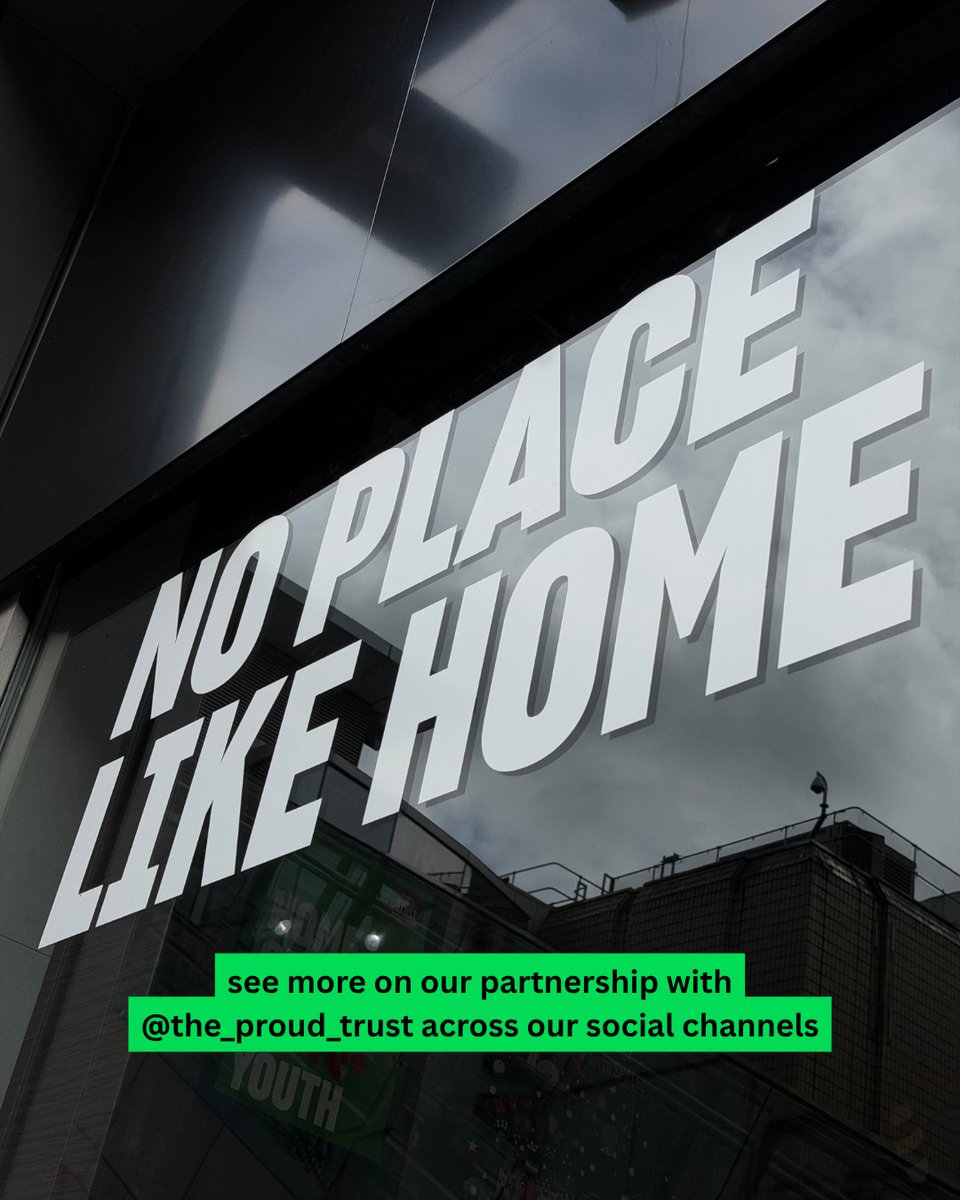 An image showing the outside of a schuh store with white text on the window that says "no place like home". Text overlaying the image says "see more on our partnership with The Proud Trust across our social channels.