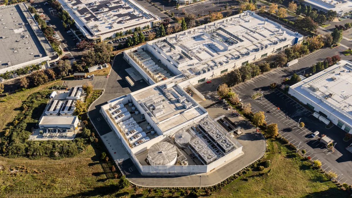 LoneStarLegendX's tweet photo. Why does a 500+ acre data center have a tiny parking lot? 

Because almost no one works there. These sites are not offices or factories. They’re giant machines.

Once built, a hyper scale campus often runs with 50–200 people on site — technicians, security, facilities. Highly automated. Mostly monitored remotely.

The land isn’t for people. It’s for:
- massive power gear
- cooling systems
- security buffers
- future expansion

Construction is the opposite: thousands of workers for a couple years. Then they leave.

That’s why the building is huge and the parking lot looks like it belongs to a dentist’s office.

So, explain to me again why giving up 500+acres for a data center that destroys the resources of the land around them and will only employ 50-200 (mostly H-1B's) is so beneficial we must bow down to them?  

Photo Credit: Reuters, Data Center Knowledge, MIT Technology Review, and Virginia Mercury.