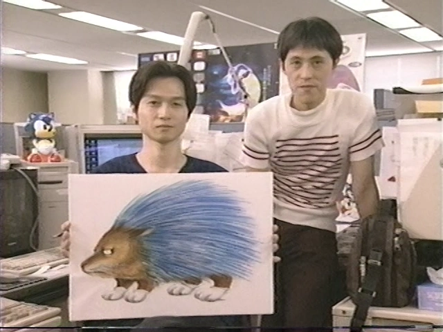 SoaHCity's tweet photo. Yuji Uekawa and Naoto Ohshima working on Sonic's redesign. Taken from the Sonic Adventure in Tokyo International Forum video. #SonicTheHedgehog https://t.co/EDSst14wSg