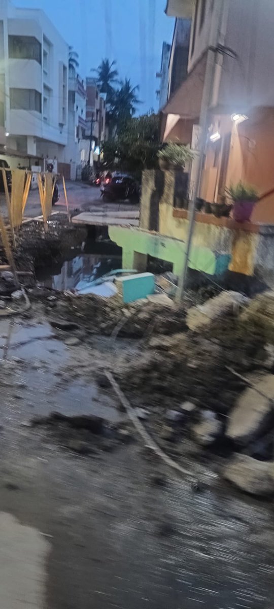 abhishekvpaul's tweet photo. @chennaicorp Photo op around generic planning sheet, shot outdoor, wearing helmets to show they're serious, etc. Meanwhile no response to complaints raised on work dragging on for months and this is the condition after one evening's rain at Kottivakam/Palavakkam https://t.co/BIDjIBOQac