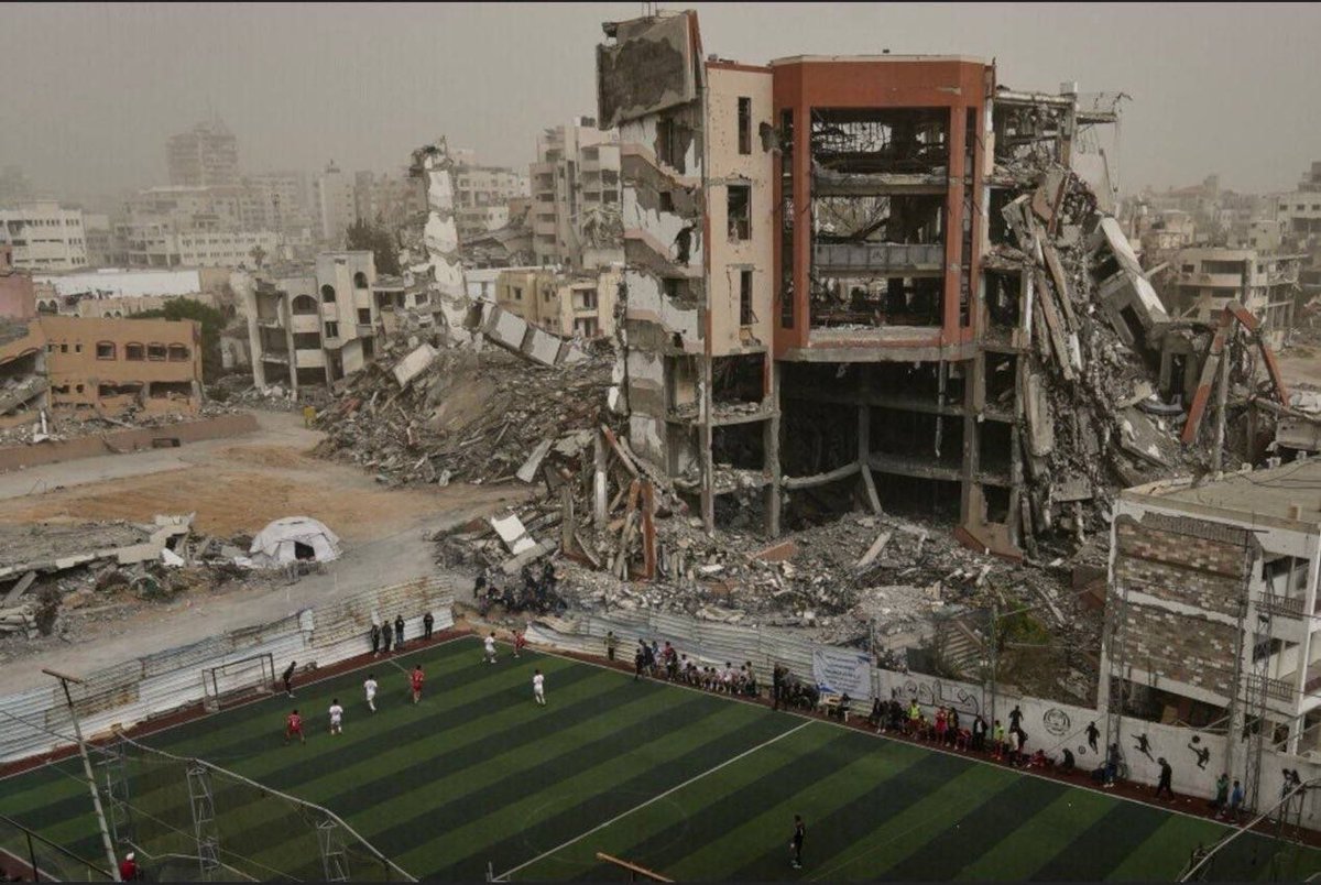 QudsNen's tweet photo. The Administrative Court of Caen has suspended the mayor of Deauville's decision to remove and censor a photograph taken by Palestinian Associated Press reporter Jehad Alshrafi.

The ruling follows legal action by the Observatory for Freedom of Creation challenging the removal of the photograph, which documented a football match in Gaza against the backdrop of buildings destroyed by Israeli attacks.

The court's decision requires Deauville's town hall to restore the photograph without delay, marking a legal victory for artistic and journalistic freedom of expression.