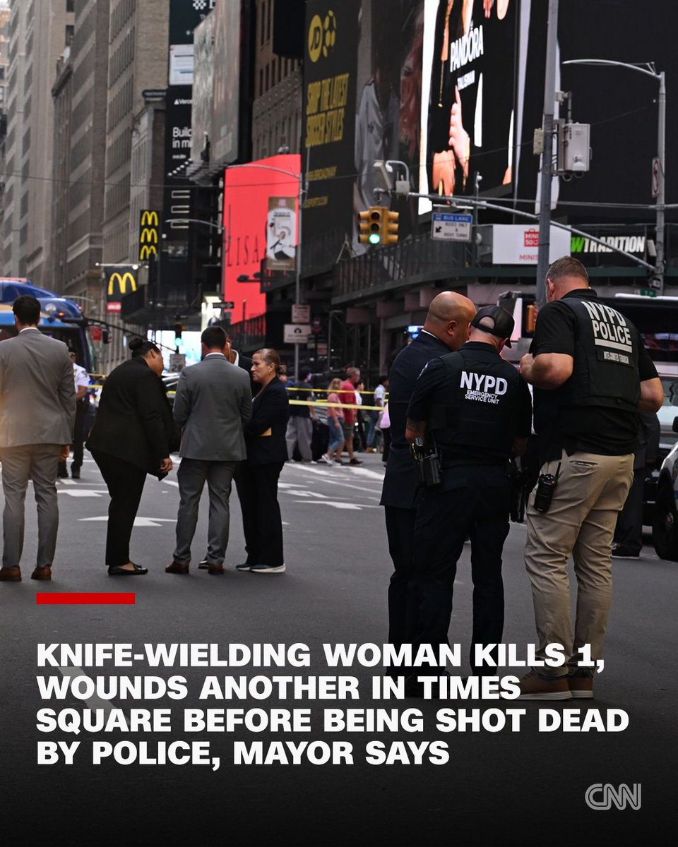 CNN's tweet photo. A woman carrying two knives stabbed two people in Times Square on Monday afternoon, killing one, before police officers shot and killed her. https://t.co/Ae2MWu4fqN https://t.co/MmJh7SrL0c