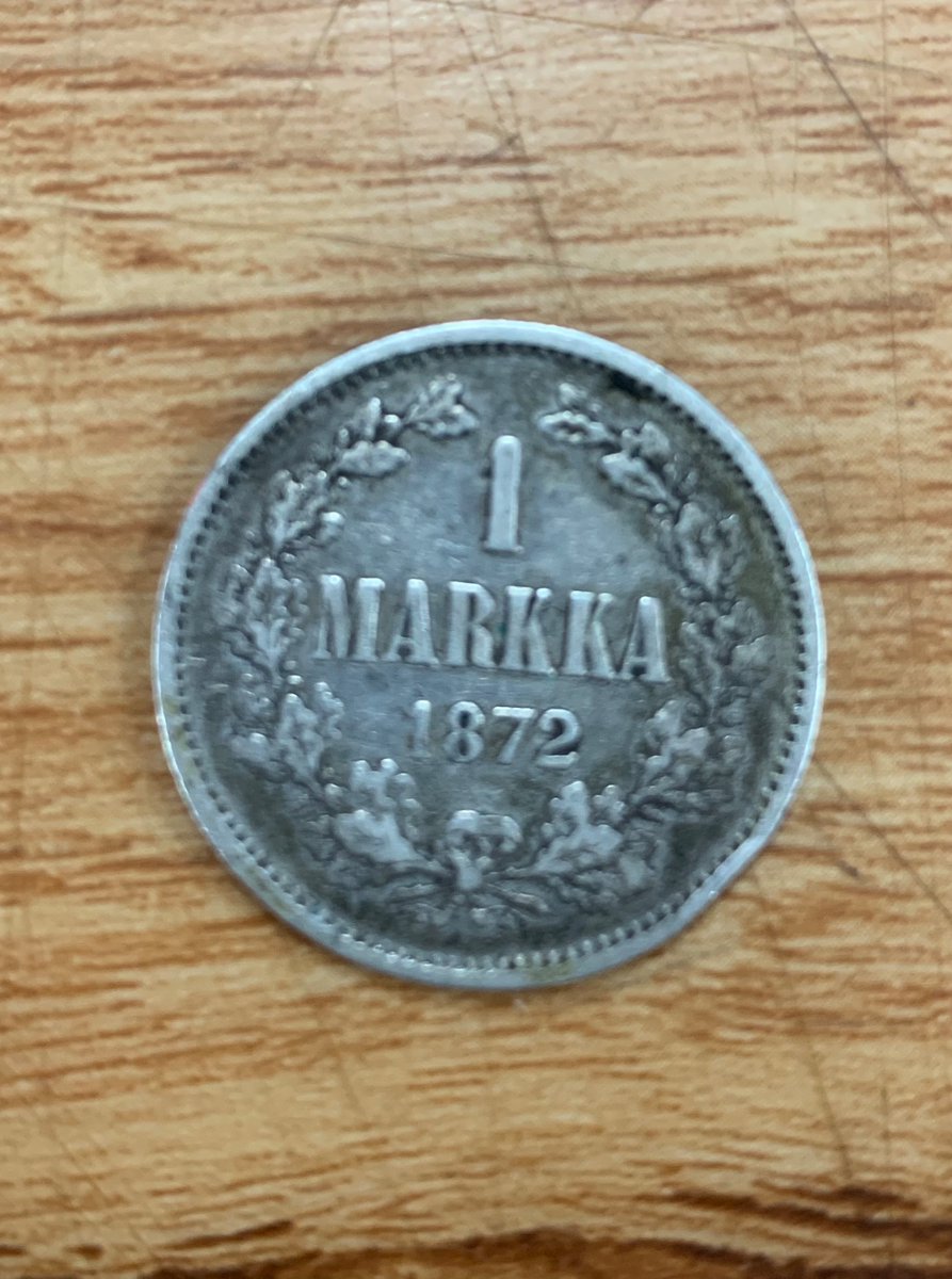 ghostcartoonist's tweet photo. One of my coworkers was handed this instead of a quarter. Roughly the same size, but this is a mark minted in Finland when it was part of Imperial Russia in 1872. What improbable sequence of exchanges got it from 19th century Helsinki to a grocery store in 21st century Berkeley? https://t.co/VkL05n8yLe