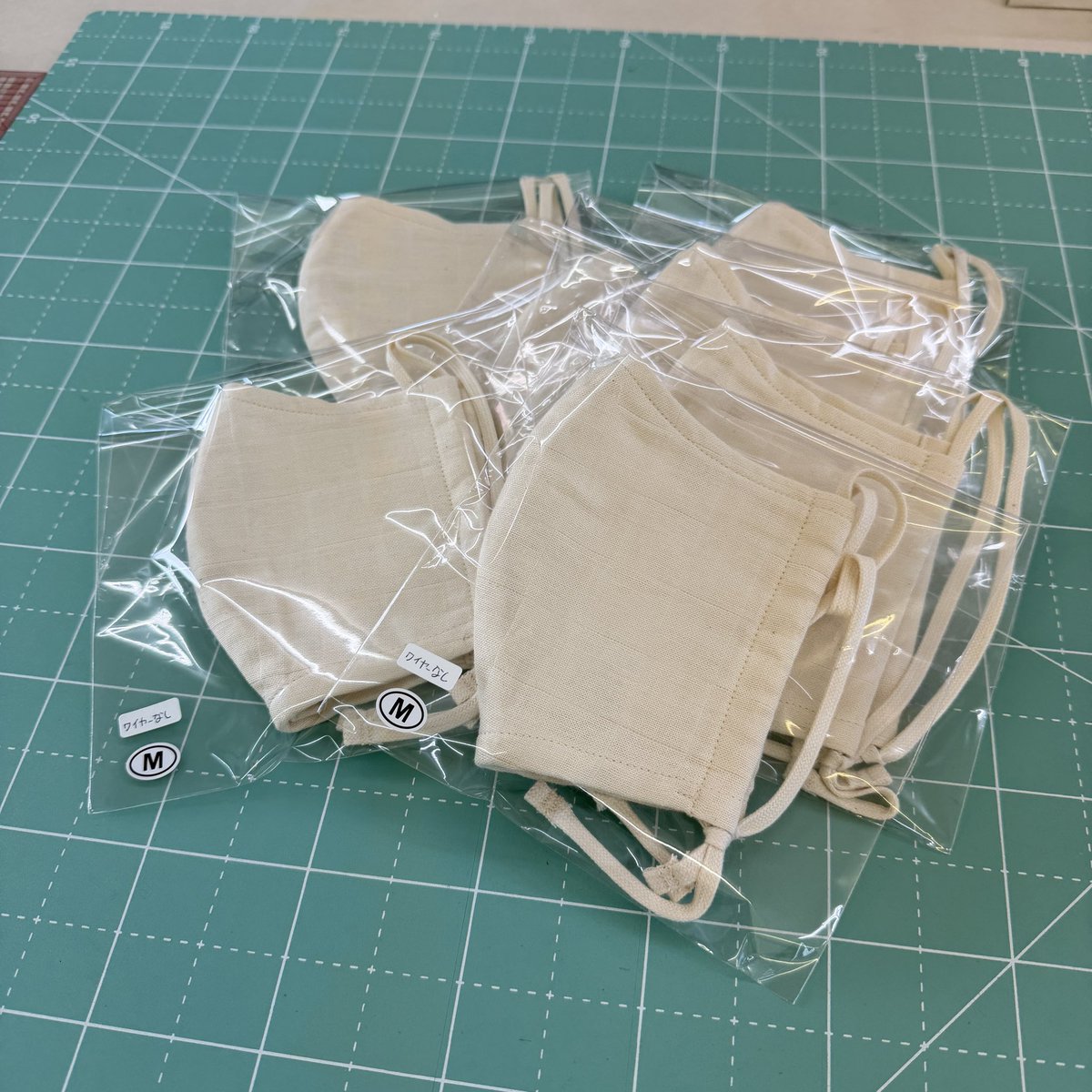 FWacca's tweet photo. 【マスク完成🪡】

ワイヤーなしの
オールコットンマスクが完成🙌

ヒモの長さ調節は
プラスチックのエイトカンを使わず
ネクタイ結びで調整します😊

出来上がったマスクは
すぐに袋詰め！

縫製takeの全体重をかけて
中の空気を抜いて圧縮🙀🤣

少しですが在庫も増えました😁✨

#wacca https://t.co/WuEELusqDF