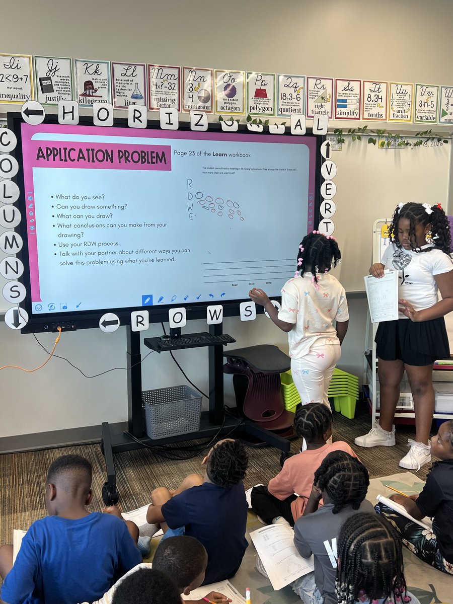 MissE_Wash's tweet photo. Before we get into the lesson, Ss complete daily word problems of previous or current learning. Ss volunteered to collaborate &amp; peer teach to their classmates! 🥳💙🧡 #nextlevellearning #growthwins https://t.co/e7QHbBdcfy
