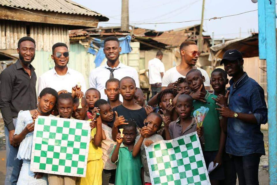 Tunde_OD's tweet photo. The beauty of setting one’s heart on.

Today marks exactly eight years since we officially kickstarted the Chess in Slums project. Oh, how beautifully time flies.

It still feels like yesterday when, with trembling hands, I committed my heart to this seemingly impossible miracle of doing great things from small places.

I feel immense gratitude today, above all things. But I also want to share a recent contemplation from one of my many mundane musings about life.

Sometime in July, while I was in New York, I decided to take a really long walk through the city. New York is a deeply fascinating place, with so much to see and admire that one can easily get lost in its allure and chaos.

So I gave myself a simple task to find and photograph everything in color blue.

Suddenly, it felt like the city changed, at least in my own eyes.

A blue bicycle chained to a railing. A stranger in a blue coat. A young boy in a blue shirt held closely by his mother, one of his hands carefully wrapped in a blue cast. Blue tents. A small patch of sky reflected in the glass of a building.

By the end of my walk, I had taken so many wonderful pictures of all the beautiful blue things my curiosity could capture.

Of course, the city hadn’t changed. The blue had always been there.

What changed was that I had decided to look for it.

I haven’t stopped thinking about that experience ever since, about the strange and beautiful power of setting one’s heart on something, and how what we choose to look for in the world eventually teaches us how to see.

It feels even more meaningful today because eight years ago, I set my heart on the Chess in Slums project, and it became my own trail of blue through the world.

It taught me to see possibility in the lives of children in places where poverty had robbed them of the basic dignity of being human beings with dreams and aspirations.

We went into those places with chessboards and a simple belief: there is remarkable brilliance here, if only someone is willing to look for it.

It has been the greatest privilege of my life to witness what happens when a child who has been invisible for most of their life finally encounters someone who sees them.

And perhaps that is another thing I have learned: we do not only find what we are looking for. Sometimes, by looking long enough and loving deeply enough, we help it become visible to others too.

These eight years have carried the full spectrum of being alive: beautiful moments, difficult years, mistakes, exhaustion, hurt, disappointment, uncertainty, and days when the size of the problem made our efforts feel painfully small.

But chess has taught me something about small things.

The pawn is the smallest, most ordinary piece on the chessboard. Yet hidden within its humble beginning is the possibility of becoming something far greater than anyone imagined.

Perhaps children are like that too.

There are still millions of children across Africa whose brilliance remains hidden behind circumstances they did not choose.

So we will keep looking.

We will keep going to the small places.

To help them burn brighter and hold them up long enough for the world to see.

And perhaps this is the beauty of setting one’s heart on something: That you begin by searching the world for a particular kind of light….

Then one day, you look around and realize you have spent your life helping to create it.

Happy anniversary, @chessinslums.

To our incredible team, volunteers, partners, friends and supporters over the years, thank you for believing, for staying, and for teaching me in the most profound way that no amount of darkness can conquer a flicker of light.

Eight years later, my heart is still set on the same thing.

This is Day One, all over again.