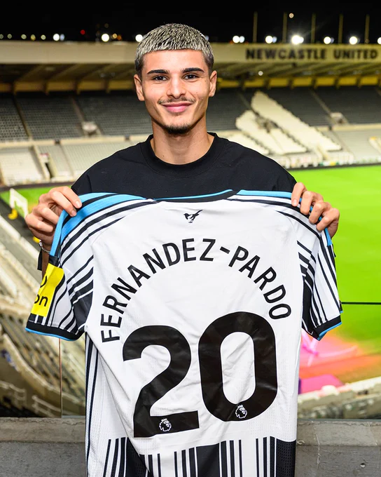 Matias Fernandez-Pardo holds up a home shirt with his name and number 20 on the back of it at St. James' Park.