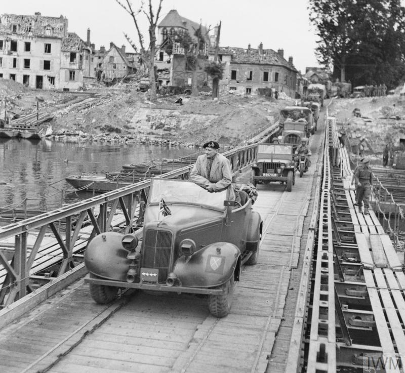 VoicesofWW2's tweet photo. Field Marshal Montgomery stands up in his 1943 Humber Super Snipe staff car as he crosses a pontoon bridge over the River Seine at Vernon, France, 1 September 1944. https://t.co/rYIwfHBOnD