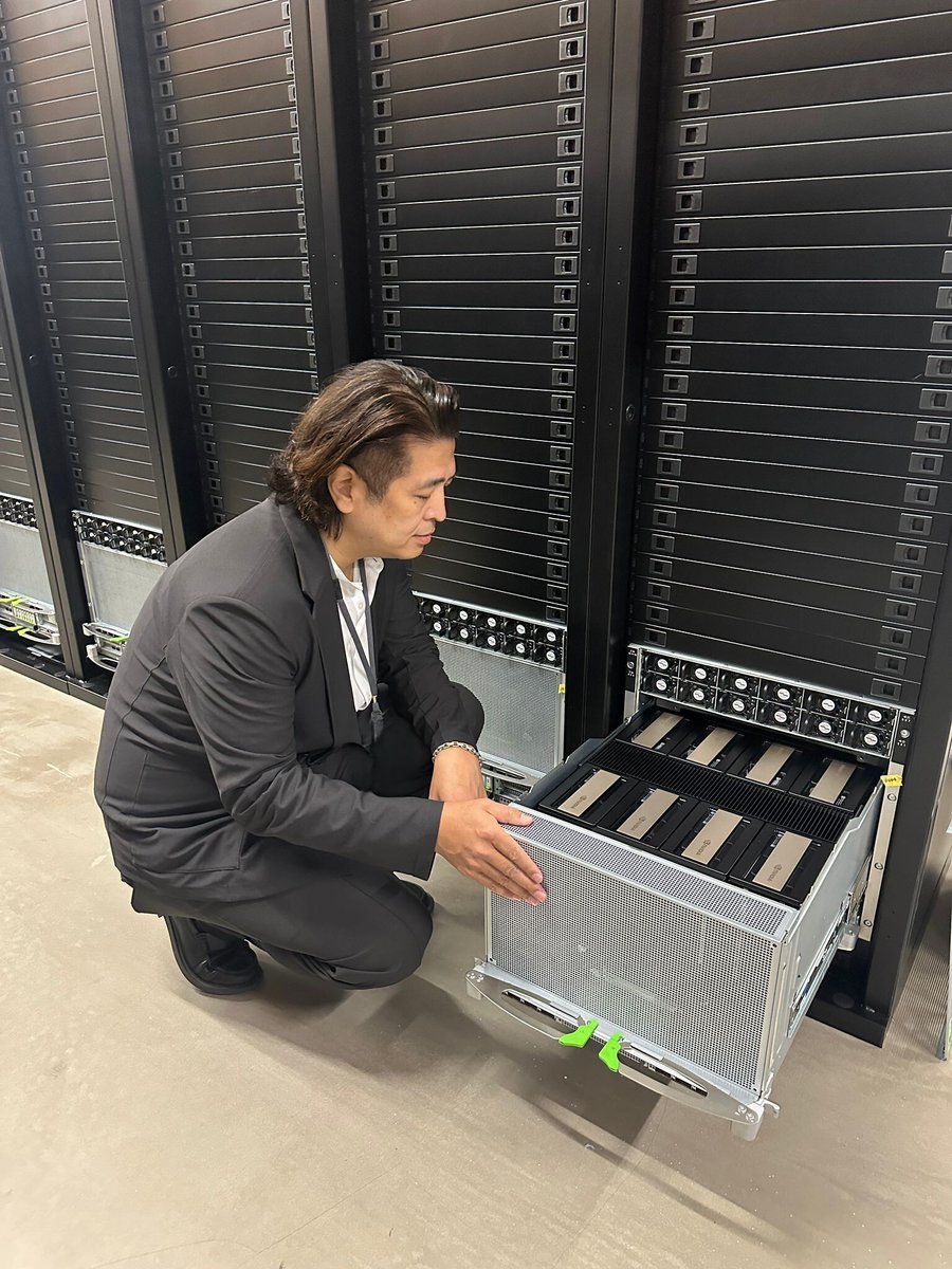 datasection's tweet photo. 先日、海外の機関投資家の皆さまに現地をご覧いただきました当社の「国内第1号AIデータセンター」に導入されたGPUに関して、Xでもご紹介したいと思います。

写真に写っているのは、NVIDIAの最新GPU「B300」を搭載したサーバーです。

【導入規模・仕様】
1台のGPUサーバーにB300を8基搭載しており、サーバー1台あたりの価格は約8,000万円。このAIデータセンターには635台、合計5,080基のB300を導入予定です。
※公開情報を当社で確認した範囲では、国内最大級のB300導入規模となります！

CPU、メモリ、ストレージについてもNVIDIAのリファレンスアーキテクチャと同一の仕様を採用しています。

【視察の際にいただいたご質問】
Q. データセンターの建物はデータセクションが所有しているのですか？
A. 建物は所有せず賃借し、当社がGPUサーバー等を設置するコロケーションモデルです。

Q. なぜこのデータセンターでは、各ラックにサーバーを1台だけ設置しているのでしょうか。何らかの技術的な制約があるのでしょうか？
A. 日本では、空冷方式を採用しているデータセンターの場合、一般的に各データホールで利用可能な電力容量に上限があります。例えば2MW程度に制限されている場合、その電力容量の範囲内では、B300 GPUサーバーを最大143台程度までしか設置できません。
ラック自体にはまだ多くの物理的な空きスペースがありますが、データセンター側でそれ以上の電力や冷却能力を提供することができないため、当社では各ラックにGPUサーバーを1台ずつ設置する構成としています。
一方、電力供給能力や冷却能力に余裕のある国では、より高密度な構成も可能です。例えばオーストラリアでは、1ラックあたりB300 GPUサーバーを3台設置する構成を採用しています。

Q. ラック上部にある赤と青の機材は何ですか？
A. 「Tap-off Unit（バスウェイ電源分岐ボックス）」です。A系・B系それぞれの電源幹線から電源を分岐し、各ラックへ冗長化された電力を供給します。

今後も、当社のAIデータセンターの設備や技術についてご紹介していきます。

#Datasection #AIデータセンター #NVIDIA #B300 #GPU #AIインフラ

We would like to introduce the GPUs installed at our AI data centre, the first of its kind in Japan, which was recently visited by a group of overseas institutional investors.
The photo shows a server equipped with NVIDIA’s latest-generation B300 GPUs.

Deployment Scale and Specifications
Each GPU server is equipped with eight B300 GPUs and costs approximately JPY 80 million. A total of 635 servers, equipped with 5,080 B300 GPUs, are scheduled for deployment at this AI data centre.
Based on publicly available information reviewed by Datasection, this represents one of the largest B300 deployments in Japan.
The CPU, memory and storage specifications also follow NVIDIA’s reference architecture.
Questions received during the site visit

Q. Does Datasection own the data centre building?
A. No. We lease the facility and operate under a colocation model, installing and operating our own GPU servers and related equipment.
Q. Why is only one server installed in each rack at this data centre? Is this due to a technical constraint?
A. In Japan, air-cooled data centres generally face a limit on the power capacity available in each data hall. For example, where the limit is approximately 2 MW, only around 143 B300 GPU servers can be installed within that power envelope.
Although the racks themselves still have considerable physical space available, the facility cannot provide any additional power or cooling capacity. Accordingly, we have adopted a configuration in which one GPU server is installed in each rack.

By contrast, higher-density configurations are possible in countries where more power and cooling capacity are available. In Australia, for example, we use a configuration of three B300 GPU servers per rack.
Q. What are the red and blue units located above the racks?
A. They are tap-off units for the busway power distribution system. They draw power from both the A and B feeds, providing each rack with a redundant power supply.
We will continue to share more about the facilities and technologies supporting our AI data centres.
#Datasection #AIDataCentre #NVIDIA #B300 #GPU #AIInfrastructure