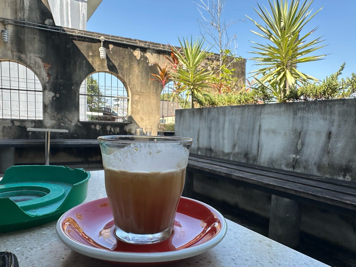 MahadmaA's tweet photo. Caught this sweet moment between a barista and a regular on a rainy corner today—small joys hit different.， https://t.co/xlboK2w14q