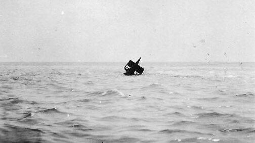 USN_Submariner's tweet photo. To hell, by compass
OTD in 1920, the following exchange took place between freighter S.S. Alanthus & what appeared to be a buoy waving a white flag, as seen in the photo:
 • Alanthus: What ship are you?
   • Submarine S-5
 • Alanthus: What nationality
   • United States
 • Alanthus: Where are you bound
   • To hell, by compass
A day earlier, S-class submarine USS S-5 (SS-110) attempted to quickly dive during a drill, but forgot to close the induction valve. Water poured into the forward compartment, forcing the crew to abandon it. They blew the main tank but quickly sank to the ocean floor 180 feet below the surface. From there they blew the aft tanks & the stern rose at a 60-degree angle with the bow still on the seabed. Struggling to stand & running out of air, the crew began using hand tools to drill through the hull at the stern. Progress was extremely slow, but they finally created a hole after 16 hours of drilling to deploy a flag made from a copper pipe & a white t-shirt. Luckily Alanthus spotted them &, after having the above exchange, worked to drill a larger escape hole. All 40 crew members survived.