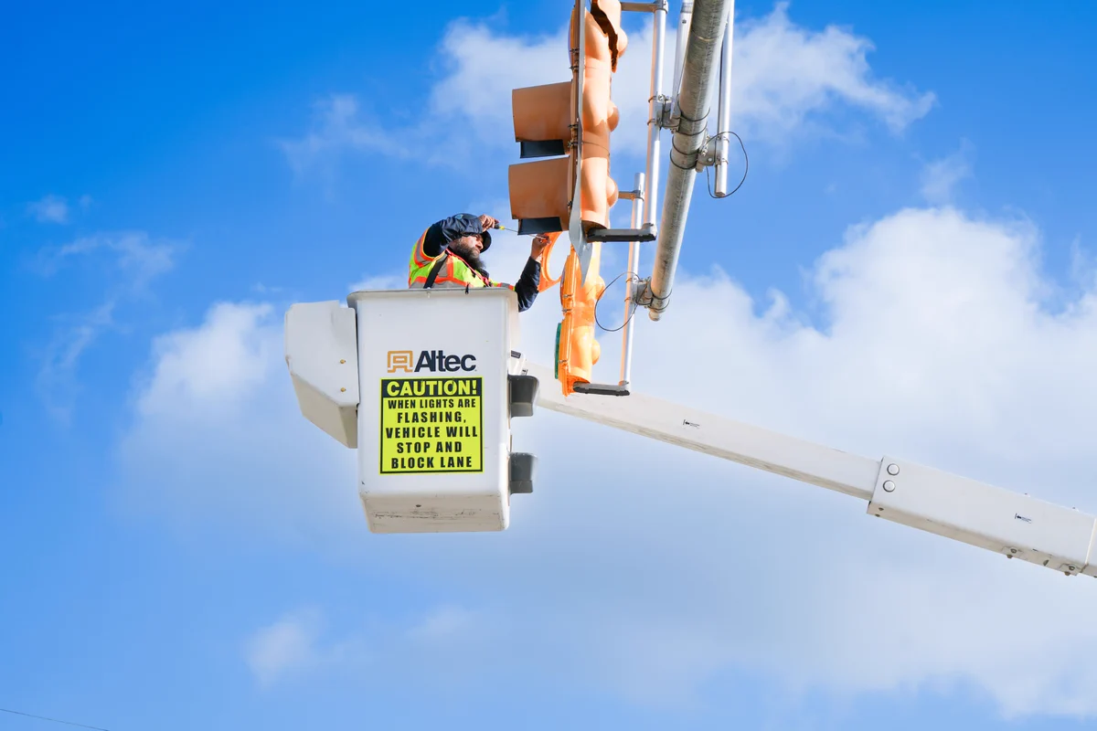 Man is lifted to fix traffic light