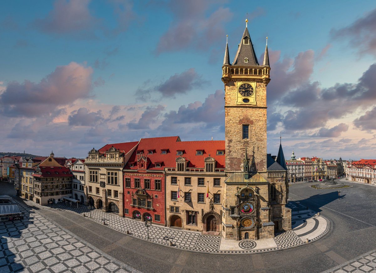 homogalactic's tweet photo. Installed in 1410, the Prague Astronomical Clock has stood over the Old Town Square for more than 600 years.

The Prague Astronomical Clock (known as the Prague Orloj) was indeed installed in 1410, making it the third-oldest astronomical clock in the world and the oldest one still operating.

Key Features of the Clock: The Astronomical Dial: Represents the positions of the Sun and Moon in the sky, showing various astronomical details. The Walk of the Apostles: Every hour from 9:00 AM to 11:00 PM, figures of the Twelve Apostles and moving mechanical statues—including a skeleton representing Death striking time—appear in the windows above the dial. The Calendar Dial: Added later in 1870, it features medallions.
The tragic legend of the clockmaker Hanuš who built it.

According to popular folklore, the genius behind the Prague Orloj was Master Hanuš (historically known as Jan Růže).

Once the clock was completed in 1410, it became the wonder of Europe. People traveled from far and wide to marvel at its complex dials, moving statues, and flawless mechanics.

The Prague City Councillors grew deeply proud of the masterpiece, but their pride quickly turned into paranoia and greed. They became terrified that Hanuš would build an even grander, more beautiful clock for another rival European city, stripping Prague of its unique glory.

To prevent this, the councillors plotted a horrific crime:
The Betrayal: A group of masked men broke into Hanuš’s workshop at night.
The Act: Acting on the council's orders, they blinded the master clockmaker with a piece of hot iron so he could never draw plans or build a clock again.
The Ultimate Revenge:
Driven mad by grief and betrayal, Hanuš knew exactly who was responsible. Weak and dying, he asked his loyal apprentice to guide him up into the clock tower one last time under the pretense of saying goodbye to his life's work.
The Sabotage: When they reached the heavy iron gears, Hanuš reached deep into the intricate mechanism and ripped out a vital component.
The Curse: The heavy machinery ground to a halt, and Hanuš collapsed and died on the spot.

Legend says that the clock cursed the city in return. It remained broken and completely silent for over 100 years because no other clockmaker in Europe possessed the genius required to understand Hanuš's design and repair it.

Historical Note: While this haunting legend has been told for centuries and was popularized by writer Alois Jirásek, historical records later revealed that the clock was actually built by Mikuláš of Kadaň and Jan Šindel. Hanuš was a real clockmaker, but he repaired and advanced the clock later in the 1490s.