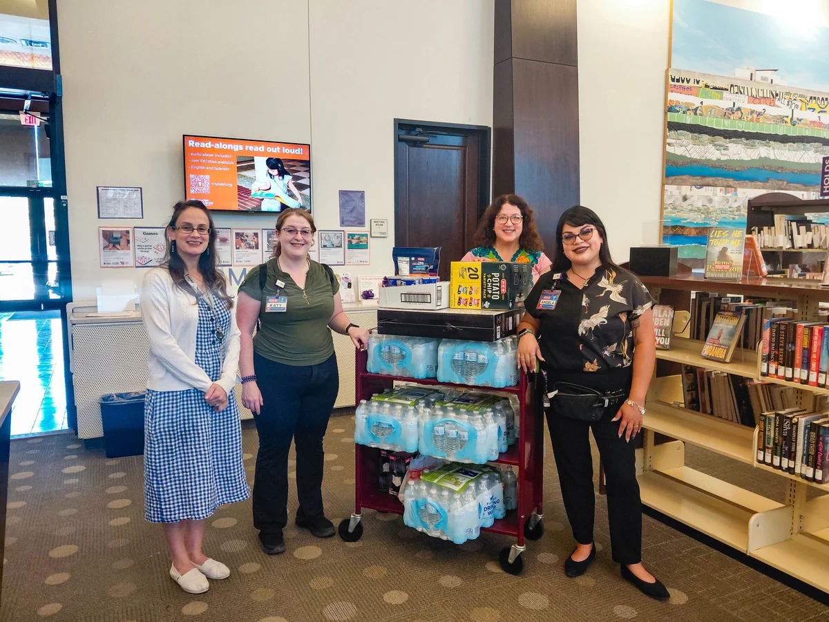 Women delivering water bottles and other supplies