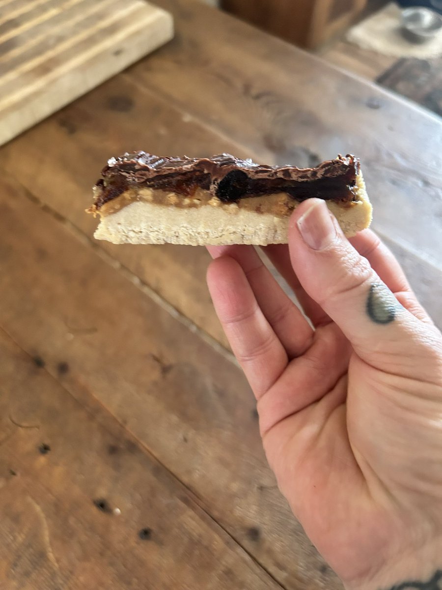 farmingandJesus's tweet photo. Healthier natural candybars 👇🏻
TRUST ME ON THIS SERIOUSLY 

they are not SUPER  low in calories about 175 per bar but they satiate and you’re not getting a bunch of processed sugar/ ingredients you can’t read. I make them for my husband and he said if I keep these on hand he will never sneak candy bars again. 

Base layer 👇🏻
3/4 cup almond flour 
1 serving of vanilla protein powder of your choice 
1tbsp honey or maple syrup 
Splash of olive oil 

Mix this up and push it tightly into a parchment lined bread pan place in freezer for 20 min then layer the rest all at once without freezing between. 

Second layer 👇🏻
Organic chunky peanut butter (do a super thin layer maybe 3 tbsp  for the whole recipe) MUST BE CHUNKY. If you can’t find REAL peanut butter that is chunky get unsalted peanuts and layer those on top of the peanut butter:)!

3rd layer 👇🏻
Smashed MEDJOOL  dates. Must be medjool and layer evenly on the whole thing.  I use about 6 smashed dates 

Top layer👇🏻
Melted dark chocolate (use a tsp of olive oil in the melting process to make it smooth) 

The sprinkle with course salt while still wet 

Freeze it all and store it in the freezer as well. 

Makes about 8 bars 🩵 they. Are. Insane.