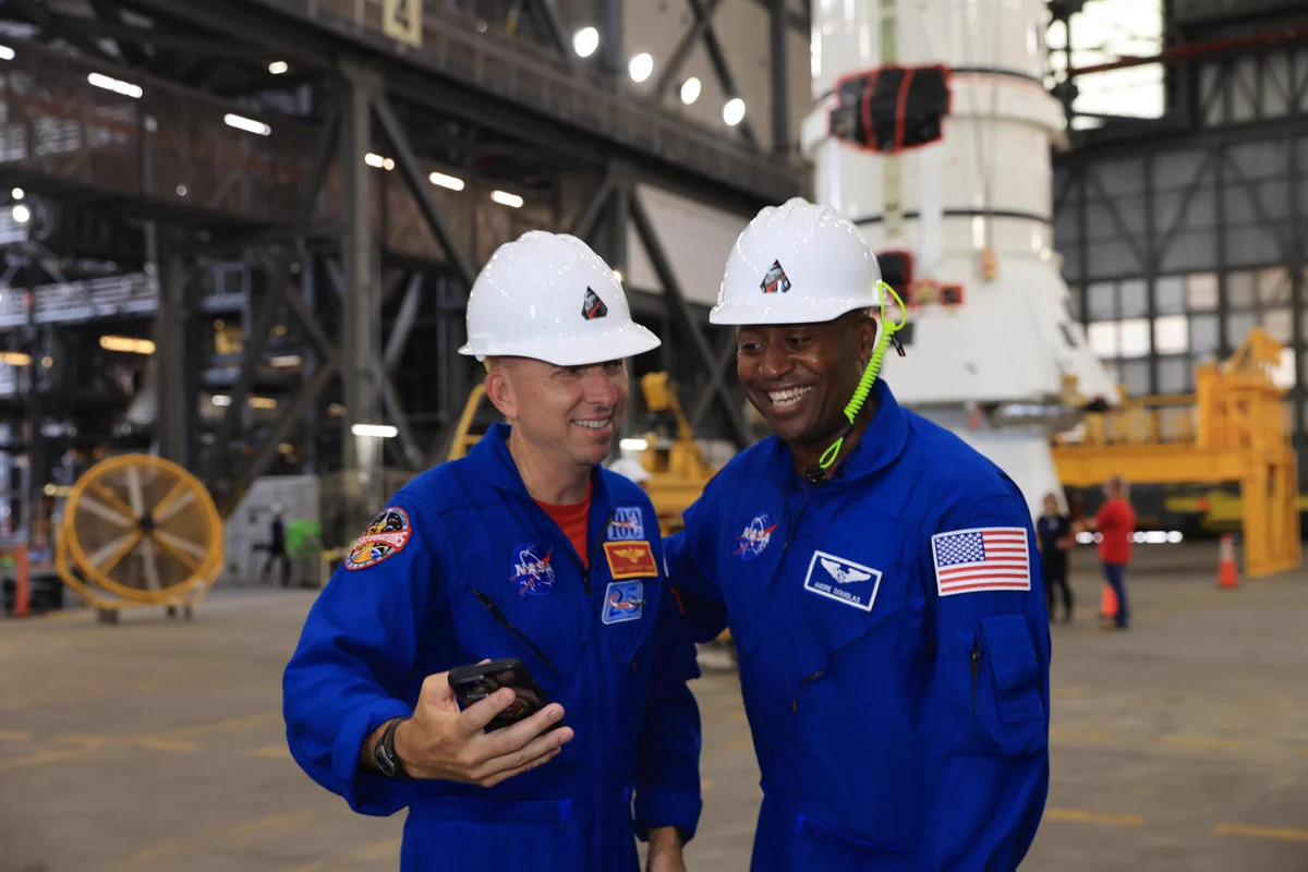 Artemis III crew members, NASA astronauts Randy Bresnick (left) and Andre Douglas, take a selfie in front of the right-hand aft assembly solid rocket booster segment of the Artemis III Space Launch System rocket inside the Vehicle Assembly Building at NASA’s Kennedy Space Center in Florida. Credit: NASA/Kim Shiflett