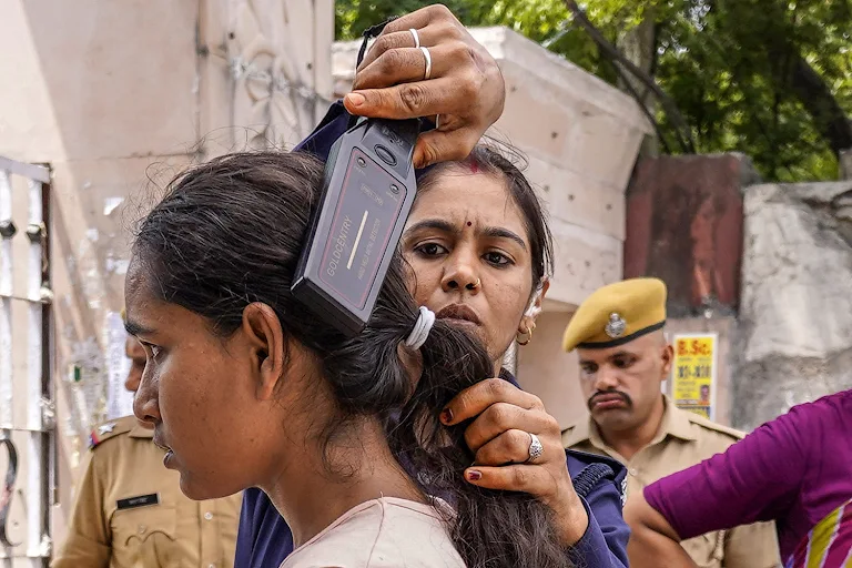 thecaravanindia's tweet photo. #NEET | A medical student being checked by police personnel before appearing for NEET. Candidates are humiliatingly strip-searched before the exam, with a level of scrutiny that the NTA itself never faces despite constant failures. 

@sujajourno  reports: https://t.co/eHVrRSerJl https://t.co/tlpojmrgDm