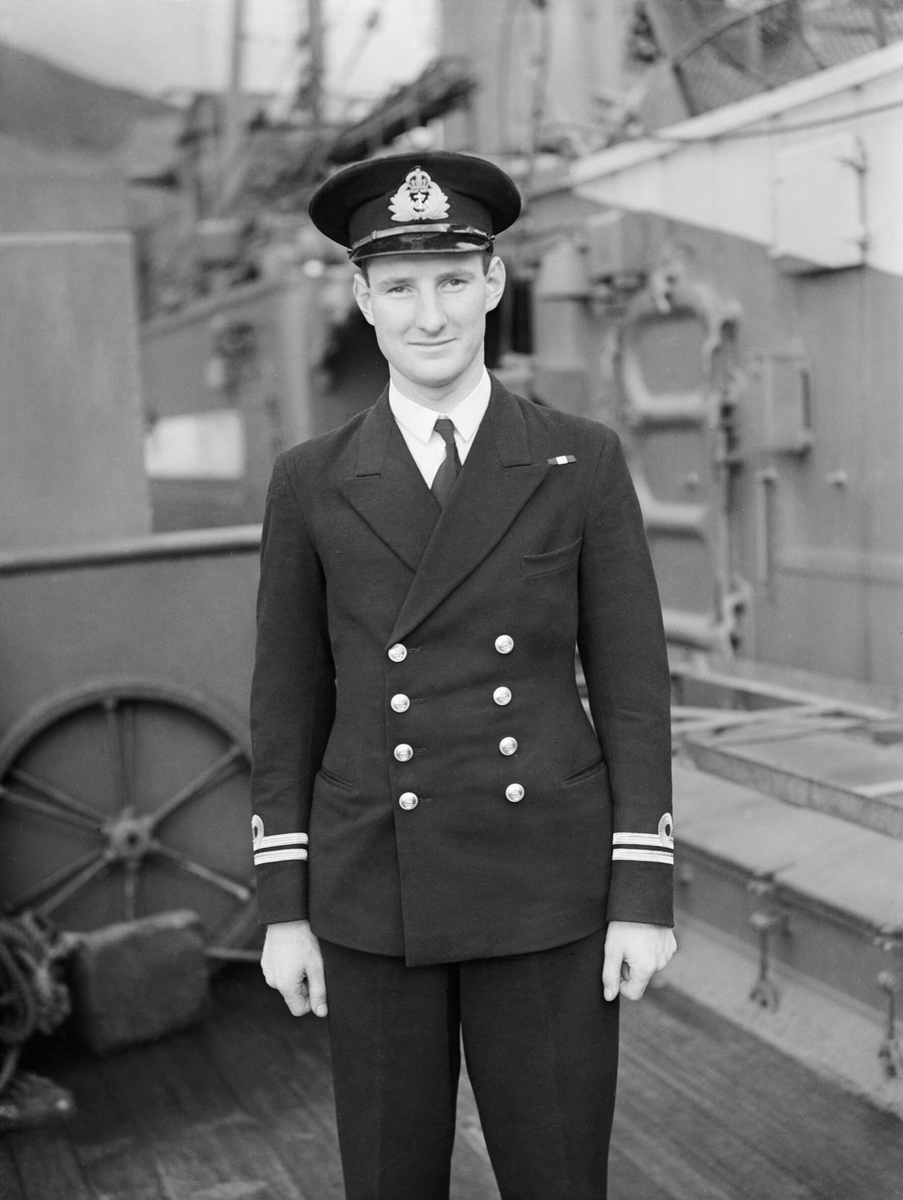 MilitaryBritain's tweet photo. Lieutenant Jimmy Launders was 25 when he tried something no submarine commander had ever achieved: sink an enemy submarine while both boats remained hidden beneath the sea. If his first salvo missed, HMS Venturer could expose herself with no way to steer the torpedoes after launch.

The target was U-864, commanded by Ralf-Reimar Wolfram. It was carrying Messerschmitt jet-engine parts, V-2 guidance systems and 64 tonnes of mercury to Japan under Operation Caesar. British intelligence had read German radio traffic and sent Venturer to wait off Fedje, north of Bergen.

On 9 February 1945, Venturer’s hydrophones picked up an engine beneath the water. Launders and his crew followed the sound for three hours. U-864 did not hold a straight course. It zigzagged and changed its position, making the normal flat torpedo calculation almost useless.

Launders chose not to wait for the U-boat to surface. His team kept taking bearings and estimated its course through three dimensions: forward, sideways and down. Venturer’s torpedoes were “fire and forget.” Once they left the tubes, no cable linked them to the submarine and no late correction was possible.

He ordered four fired at intervals of 17½ seconds, spreading them across the places U-864 might turn or dive. The German crew heard them and evaded the first three. In escaping those tracks, U-864 moved into the path of the fourth. The hit tore the boat in two. Everyone aboard died.

I recovered this photograph of Launders aboard Venturer before the patrol. The face is young; the record behind it is not. He had placed his boat in the best possible firing position, trusted a solution built from sound and judgement, and ended a secret attempt to move advanced German weapons technology to the Far East. He received a Bar to his Distinguished Service Order for gallantry, judgement and skill.

Venturer was later sold to Norway and eventually broken up. The result of that submerged duel has never been repeated. The Royal Navy still teaches the method Launders used, and the old submarine’s bell has been passed to the crew of the new HMS Venturer. The steel disappeared; the calculation did not.