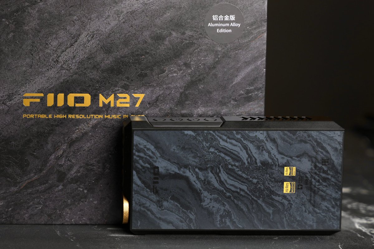 Earside_HiFi's tweet photo. @FIIO_official M27: The Hassle-Free Solution for Driving High-End Headphones 

Type: Portable Digital Audio Player 

Price: $2,199 USD 

FiiO releases new products at a rapid pace, but the company has always been careful with flagship updates. The previous flagship, the M17, arrived in 2021. It became a benchmark for what FiiO could achieve: powerful hardware, extensive features, exceptional output power, and remarkable versatility. Even today, the M17 remains one of the most complete DAPs on the market. If portable audio had a Hall of Fame, the M17 would deserve a place in it. 

As the successor to the M17, the M27 attracted significant attention long before launch. The final product has largely met expectations. Driven by strong word-of-mouth within the audiophile community, sales reached several thousand units shortly after release. More notably, many owners use flagship headphones such as Focal Utopia and MEZE ELITE - something rarely seen among M17 users. 

Back during the M17 era, FiiO introduced the idea of a “portable desktop-class amplifier.” In reality, the M17 could drive full-size headphones competently, but it still felt like a secondary feature. Four years later, the concept has matured. The improvements are not limited to specifications. The sonic foundation and headphone synergy have advanced significantly. (Note: This review is based on the aluminum version of the M27. Other editions may differ slightly.) 

Hardware: A Major Leap Forward 

FiiO openly published a full specification comparison between the M27 and M17. The changes are substantial. The M27 uses Qualcomm’s QCS6490 platform, built on the same architecture as the Snapdragon 778G, paired with 8GB RAM and 256GB storage. As streaming apps continue to grow larger and more demanding, this hardware should ensure long-term responsiveness and smooth operation. 

For audio duties, the M27 employs dual ES9039SPRO DACs. Compared to the previous generation, performance improves while power consumption is reduced. Bluetooth duties are handled by the Qualcomm QCC5181, supporting aptX Lossless for wireless lossless reception. Maximum headphone output reaches 5000mW, roughly 40% higher than the M17. 

Practical design upgrades are equally important. The M27 retains a 6.35mm single-ended output. For many imported headphones that still ship with single-ended cables, this is genuinely useful and avoids unnecessary adapters. Dual microSD card slots provide expanded storage flexibility. A standard optical output joins the RCA coaxial connection, making integration with desktop systems and speaker setups easier. External power now uses USB-C, accompanied by a dedicated desktop mode switch. These refinements noticeably improve day-to-day usability. 

The trade-offs remain obvious. The M27 is large. It is heavy. Heat output is substantial. Those compromises are inevitable when pursuing desktop-class performance in a portable form factor. 

Sound: FiiO’s New Flagship Tuning Philosophy 

The M27 represents FiiO’s latest flagship tuning philosophy. Since expanding into the desktop Hi-Fi market, FiiO’s higher-end products have adopted a more traditional Hi-End approach. This is not about adding coloration, artificial warmth, or exaggerated vocal focus. Instead, the focus is on soundstage structure, hierarchy, density, control, and tonal refinement. Products like the K9 Pro and the newer K17 already demonstrated this shift. Technical performance did not improve dramatically on paper, yet the K17 delivered noticeably better stability, stronger micro-detail retrieval, and a richer, more engaging presentation. 

The same evolution is apparent when comparing the M27 to the M17. The M17 could occasionally sound slightly hollow when driving demanding flagship headphones during complex passages. The M27 sounds far more grounded and authoritative. A simple analogy: The M17 resembles pudding. Soft, elastic, pleasant, and spacious, but somewhat loose in structure. The M27 resembles premium gelato. Dense, compact, focused, controlled. 

Soundstage size remains similar, but the M27 delivers a darker background, higher information density, stronger image focus, and significantly improved instrument placement. Details never spill forward unnaturally. Every element remains stable and clearly organized within the stage. This sense of control was previously found in desktop products such as the FiiO K19 and R9. The M27 successfully brings that level of refinement into a portable device.Its starting point is simply higher than the M17. 

Balanced, Natural, and Musical 

The M27 continues FiiO’s long-standing flagship philosophy: balanced and faithful reproduction. More importantly, it achieves neutrality without sounding sterile. 

Many listeners associate highly resolving sound with dryness or harshness. That assumption is especially common with ES9039SPRO-based devices. In reality, much of the so-called “digital sound” comes from insufficient implementation. Weak power delivery and poor signal handling often create a flat, thin presentation. When properly implemented, the ES9039SPRO is neither cold nor mechanical. The M27 demonstrates this clearly. It extracts excellent technical performance while maintaining natural timbre and emotional engagement. The midrange carries a subtle touch of warmth that gives vocals a convincing sense of life. 

For example, take Libiamo ne’ lieti calici (Brindisi) from Verdi’s La Traviata, performed by Luciano Pavarotti and Dame Joan Sutherland. Pavarotti’s lower register is rich and resonant. His upper range remains open and metallic without becoming aggressive. Sutherland’s soprano is smooth and airy. Together, they create a compelling contrast. As the orchestra and choir build, string textures become increasingly apparent. The atmosphere expands naturally. Dynamic swings are reproduced with confidence and control. Small inflections remain intact. Large-scale crescendos never feel strained.

The Real Advantage: Headphone Driving Power 

The M27 is not designed to impress with exaggerated first-listen effects. Its strength lies elsewhere: consistency, control, power. Among portable devices of similar size, it is one of the very few that can genuinely drive high-end full-size headphones well. Many portable products advertise large power numbers. Some excel in specific areas but struggle elsewhere. Common issues include muddy bass, compressed dynamics, and limited separation.The M27 avoids these pitfalls. The sonic foundation remains stable. Power reserves are abundant. Control is maintained.

With standard operation, Medium Gain is sufficient for headphones like the FT7 and MEZE 109 PRO. The presentation remains spacious, fast, and clean. For more demanding models such as the Sennheiser HD 800 S, MEZE ELITE, and HIFIMAN HE1000 Unveiled, connecting external power and activating Super High Power Headphone Mode unlocks the M27’s full capability. Many hybrid desktop-portable devices simply increase volume and soundstage when switching into desktop mode. Excitement rises, but control suffers. The M27 takes a different approach. It preserves headroom. It maintains composure. Dynamics remain balanced. Energy is delivered without excess. The result is impressive versatility. Solo recordings sound delicate and nuanced. Large orchestral works retain scale and authority. The HD 800 S gains low-frequency presence often missing from portable setups. The MEZE ELITE benefits from improved resolution and stage expansion. While dedicated desktop systems can still extract the final percentage of performance, the M27 already surpasses many desktop amplifiers in overall execution. 

The few desktop systems that clearly outperform it are typically much larger and significantly more expensive. 

Equally Impressive with Flagship IEMs 

The M27 is not only a headphone powerhouse. It also performs exceptionally well with flagship IEMs. 

Take the Noble VKRP for example. Many portable devices struggle to fully open its soundstage and separation. Desktop gear is often required to unlock its full potential. The M27 handles it remarkably well. Lateral expansion is convincing. Layering is excellent. Instrument positioning approaches flagship headphone territory. Treble remains controlled without becoming aggressive. Other high-performance models such as the Sennheiser IE 900 and Astell&Kern LUNA also benefit from the M27’s neutral foundation. Their individual tuning characteristics remain intact while technical performance is fully realized. Whether used as a reference source for reviews and exhibitions or as a universal solution for owners of multiple headphones and IEMs, the M27 stands out as one of the strongest options around $2,000. 

Conclusion 

The market has changed dramatically since the M17 launched in 2021. Today, $2,000–$4,000 flagship DAPs and IEMs are commonplace. Against that backdrop, the M27’s pricing feels surprisingly restrained. The M17 was already an outstanding product. The M27 improves upon it in nearly every meaningful area. 

Its understated marketing and engineering-focused image may cause some listeners to overlook it when discussing top-tier flagship DAPs. Objectively, the M27 competes comfortably with flagship players priced below $4,000. When it comes to driving full-size headphones, very few portable devices in its class can match it. 

More importantly, it finally delivers on the promise FiiO first introduced years ago: a true portable desktop-class audio system.