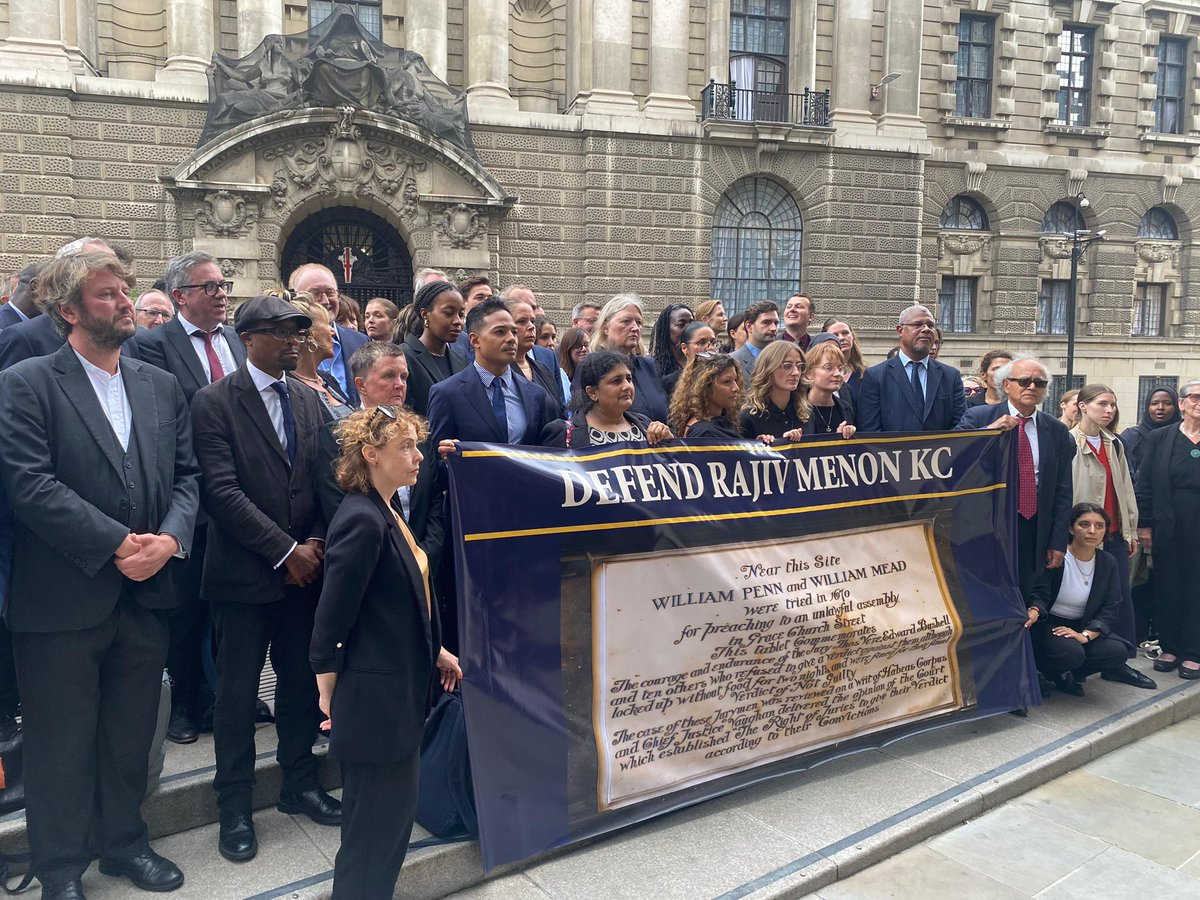 DefendourLawyer's tweet photo. Barristers, solicitors, judges and supporters gather outside the Old Bailey on the anniversary of Bushel’s case in 1670. The event was in order to show support and solidarity for Rajiv Menon KC, whom the senior judiciary is attempting to imprison for words spoken by him during a closing speech on 8/1/26 at Woolwich Crown Court. 

Menon is believed to be the first barrister in British history to be prosecuted for contempt of court for words spoken during a closing speech.