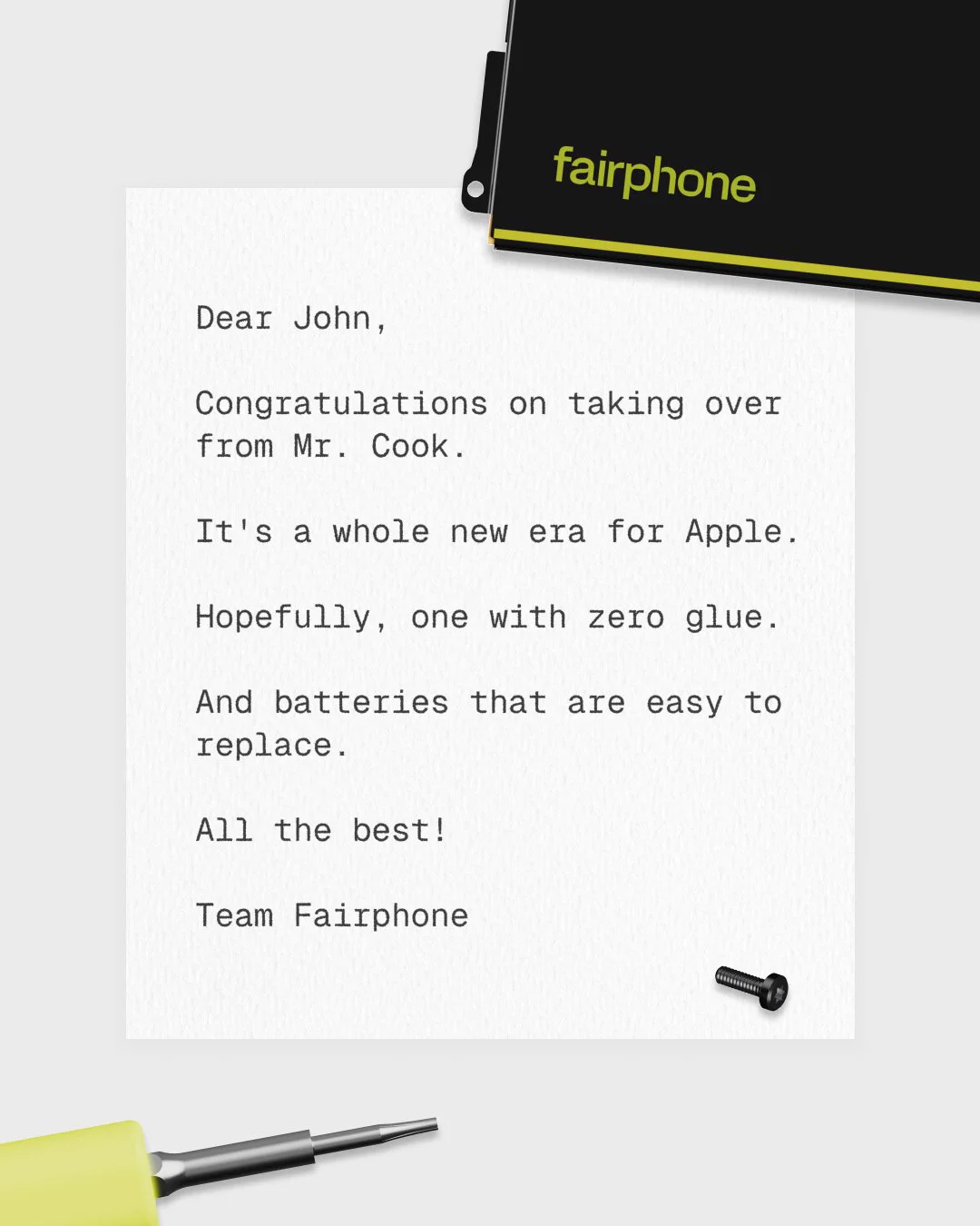 This image shows a typed letter on a white background, addressed to "John," congratulating them on succeeding "Mr. Cook" at Apple. It expresses hope for an era of easily replaceable batteries without using glue. A Fairphone logo is visible at the top right, and a small screwdriver and screw are placed on the paper. The letter is signed by "Team Fairphone.