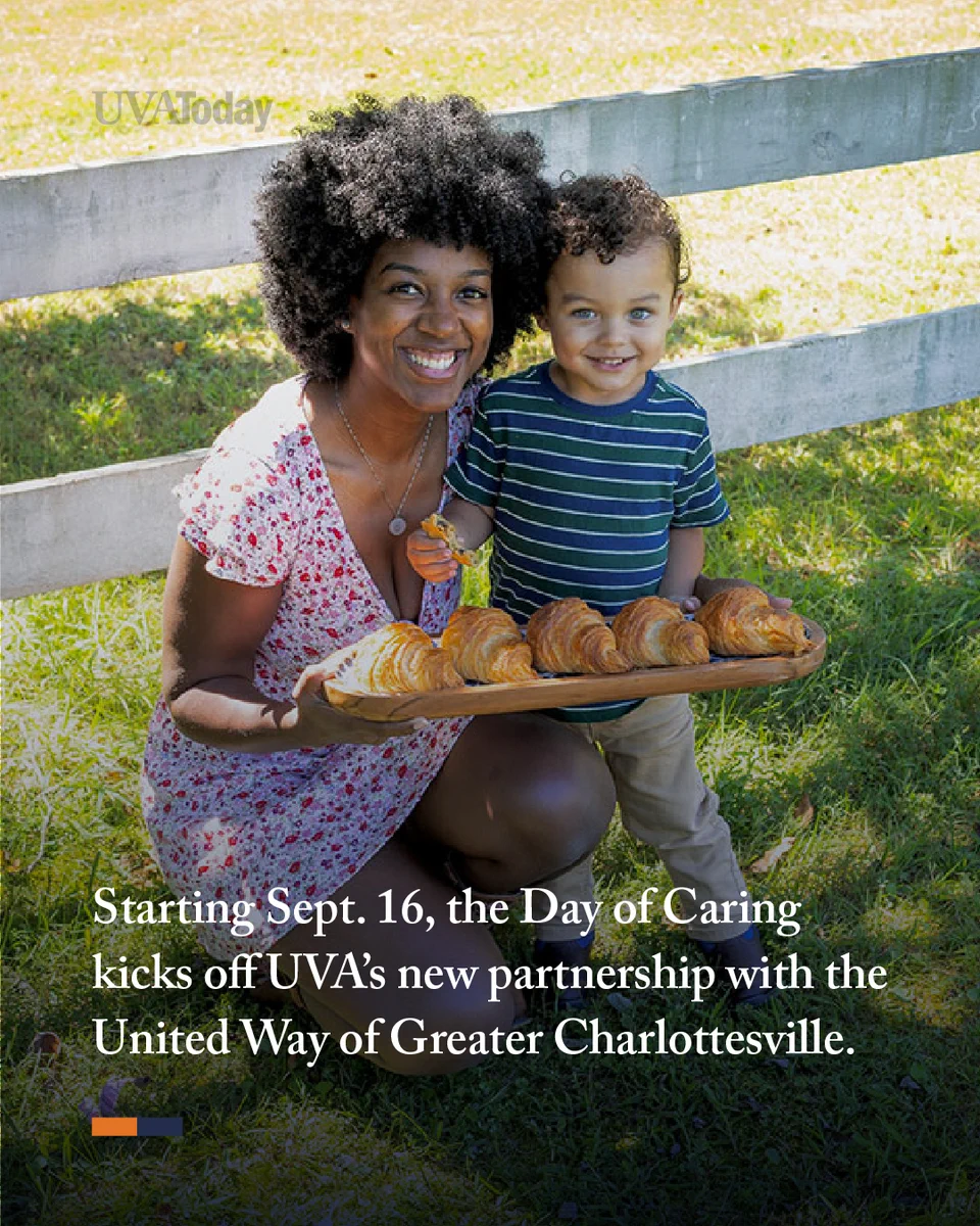 A person and a child smile while holding a tray of pastries outdoors, near a wooden fence. The image promotes UVA’s new partnership with the United Way of Greater Charlottesville and the Day of Caring event starting Sept. 16.