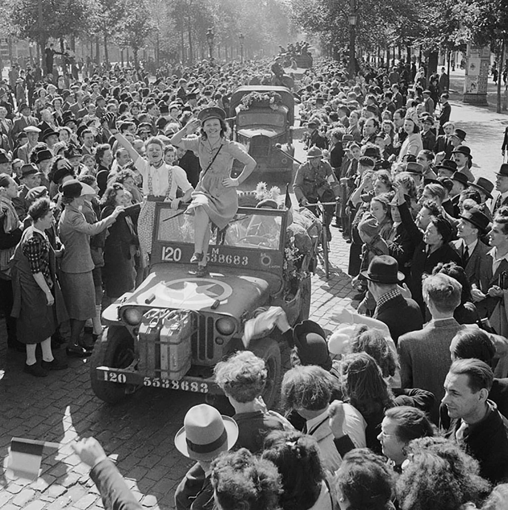 VoicesofWW2's tweet photo. September 3, 1944. Five years to the day after Britain declared war, British tanks roll into Brussels, and the capital of Belgium erupts in one of the wildest celebrations of the entire liberation of Europe. After the breakout from Normandy, the Allied armies were moving so fast that they covered the ground in a headlong rush, and Brussels fell almost before the Germans knew it was threatened.

The context was the great pursuit. After the German army in France was shattered at Falaise and the Allies broke out, they raced east and north across France and into Belgium at astonishing speed, the tanks covering enormous distances in days, the Germans in headlong retreat, barely able to form a defensive line anywhere. Paris had been liberated at the end of August. Now it was Belgium's turn.

The Guards Armoured Division of the British Second Army made a spectacular dash for Brussels, covering something like 75 miles in a single day, an extraordinary advance, to reach the city on the evening of the 3rd. The Germans, caught off balance, could not hold it. The British tanks rolled into the capital in the early evening, and the city simply exploded with joy.

The scenes were incredible, even by the standards of a liberated city. After four years of occupation, the people of Brussels poured into the streets in their hundreds of thousands, mobbing the tanks, climbing all over them, showering the soldiers with flowers, fruit, kisses, and drink, waving flags that had been hidden for years, weeping and singing and dancing. The advance essentially came to a halt because the tanks could barely move through the ecstatic crowds. It was chaos, joyous chaos, one of the great outpourings of relief and gratitude of the whole war.

There was hard fighting still, some German resistance in the city and, the next day, the vital capture of the great port of Antwerp nearby, taken with its docks almost intact, a huge prize the Allies desperately needed. But the 3rd belonged to Brussels and its liberation.

There is a neat and moving symmetry in the date. On September 3, 1939, Chamberlain had told a grim, frightened Britain that it was at war. Five years to the day later, on September 3, 1944, British soldiers were being kissed and garlanded by the free people of a liberated European capital. The war was very far from over, and hard months lay ahead, including the disaster at Arnhem just weeks away. But on this date the contrast between the beginning and the turning of the war could hardly have been sharper.