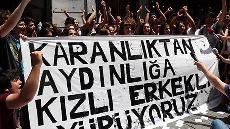 ToplumsalMht139's tweet photo. Karma eğitim neden tekrar gündemde?

81 ilden 335 sivil toplum kuruluşu, karma eğitimin zorunlu olmaktan çıkarılması ve kız ve erkek çocuklar için ayrı okullar açılması çağrısında bulundu. Bundan önce de Yeni Akit, “Karma eğitim sona ersin”, “Asrın yanlışından dönülsün” gibi ifadelerle karma eğitimi hedef alan sürmanşetler atmıştı. 

Peki karma eğitim yeniden nasıl gündeme geldi?

AKP iktidara geldiğinden beri değiştirmek istediği birçok meseleyi toplumun talebi ve halkın gündemiymiş gibi sunuyor. Ardından medya organlarını kullanarak kamuoyunda algı oluşturuyor ve yapmak istediği değişiklikler için meşru bir zemin hazırlıyor.

Akit ve diğer yandaş medya organlarının işlevlerinden biri de iktidarın kritik konularda yapacağı değişiklikler için halkın nabzını ölçmek.

Oysa yeni eğitim-öğretim döneminin başlamasıyla velilerin okul masraflarına yönelik tepkisi artıyor. Okulu terk etme oranları, güvenlik ve hijyen sorunları, devlet okullarının giderek paralı hale gelmesi ve özel okulların yaygınlaşması gibi çok daha temel sorunlar bulunuyor.

Karma eğitime yönelik saldırılar bugün ortaya çıkmış değil. Yıllar içerisinde eğitim sisteminde yapılan çeşitli değişikliklerle bu tartışmanın zemini adım adım oluşturuldu.

4+4+4 sistemiyle başlayan süreç; imam hatip okullarının yaygınlaştırılması, meslek liselerinde cinsiyete dayalı bölümlerin artması, hafızlık okulları ve okullarda kız ve erkek öğrencilerin farklı alanlarda tutulmasına yönelik uygulamalarla devam etti. ÇEDES programı kapsamında da öğrencilerin kız ve erkek olarak ayrıştırılmasına yönelik uygulamalar gündeme geldi.

HÜDA PAR, okullarda zorunlu karma eğitimin kaldırılması ve kız ile erkek öğrencilere ayrı okul veya sınıflar açılabilmesi amacıyla 17 Temmuz 2026’da TBMM’ye kanun teklifi sundu. Teklifte velilere karma veya ayrı sınıf/okul arasında tercih hakkı tanınması isteniyor.

Geçtiğimiz yıl “Gerekirse kız okulları da açabilmeliyiz” açıklamasıyla gündeme gelen Eğitim Bakanı Yusuf Tekin’in sözleri doğrultusunda, meslek liseleri bünyesinde yalnızca kız öğrenciler için 8 ilde ortaokullar açıldı.

Peki bu uygulamanın kaybedeni kim olacak?

Başta kız çocukları olmak üzere yoksullaştırılmış halkın çocuklarını.

Zorunlu eğitimin süresinin kısaltılması da yalnızca bir eğitim politikası meselesi değildir. Böyle bir adım, çocukların daha erken yaşta eğitimden koparak ucuz iş gücüne dönüşmesinin önünü açarken; kız çocuklarının eğitimden uzaklaştırılması, erken yaşta evlilik ve çocuk sahibi olma gibi sonuçları da beraberinde getirebilir.

Asıl tartışılması gereken, nasıl bir eğitim sistemi istendiği, eğitimin kimin çıkarına göre şekillendirildiği ve çocukların eşit, nitelikli ve kamusal eğitime erişiminin nasıl korunacağıdır.