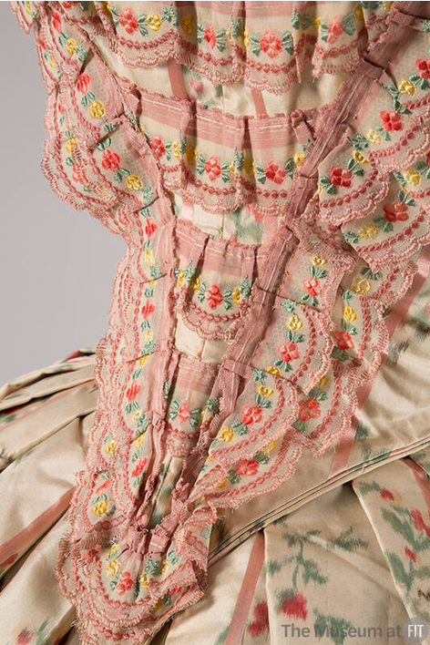 plummie9's tweet photo. American

Pretty Evening Dress, c. 1855

Floral printed silk taffeta, pink satin, white linen, chenille, and ribbon. Silk lining.

" By the 1850s, the fashionable silhouette  had reached extreme proportions, thanks to the crinoline. The floral  motif and delicate scalloped ribbon of this dress further exemplify how  women’s clothing diverged from men’s clothing. While tailored men’s  suits project rationalism and power, women’s wear became increasingly  associated with ornamentation and “frivolity.” "

@FIT 
#FashionHistory